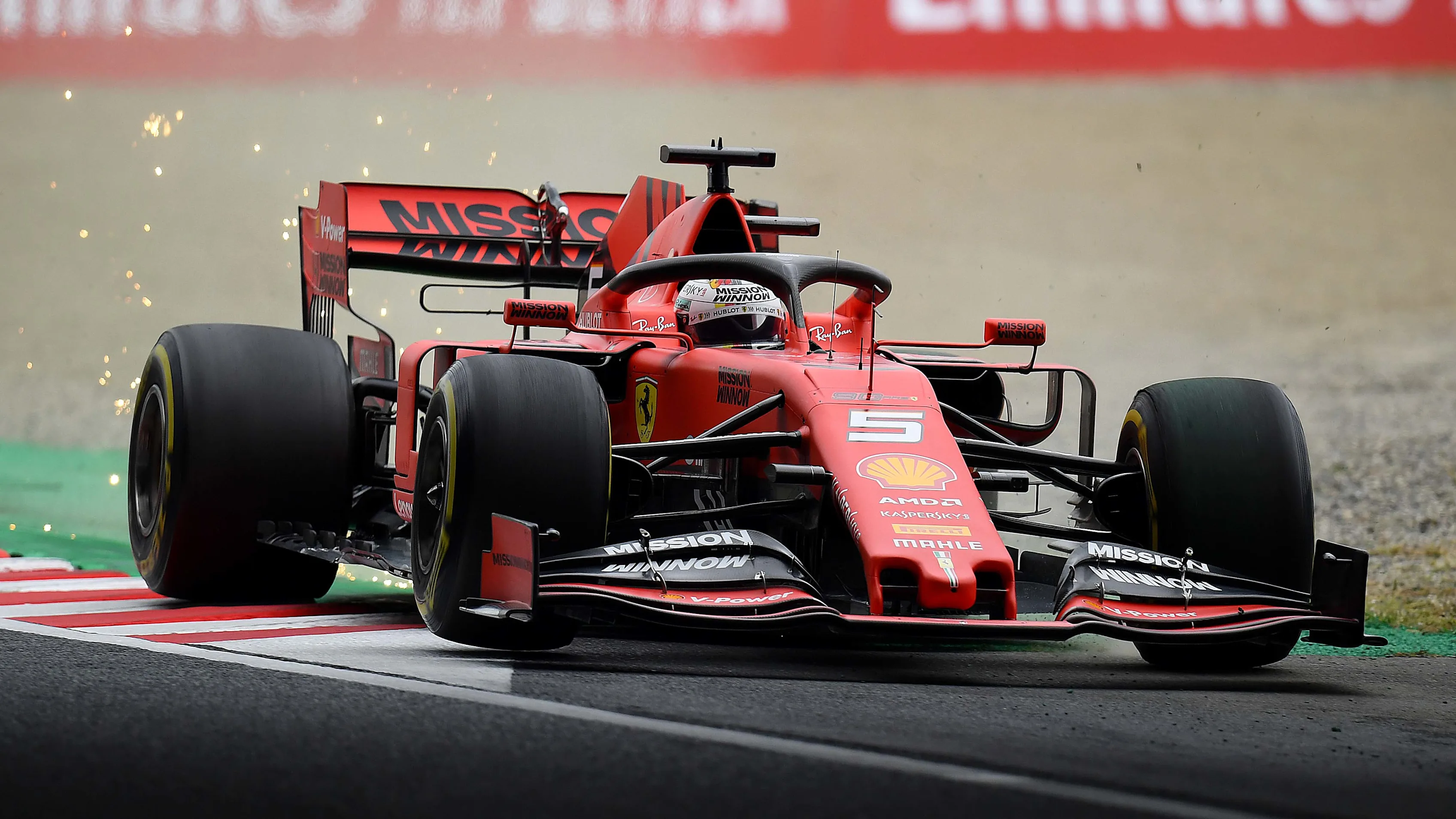 SUZUKA, JAPAN - OCTOBER 11: Sparks fly behind Sebastian Vettel of Germany driving the (5) Scuderia Ferrari SF90 on track during practice for the F1 Grand Prix of Japan at Suzuka Circuit on October 11, 2019 in Suzuka, Japan. (Photo by Clive Mason/Getty Images)