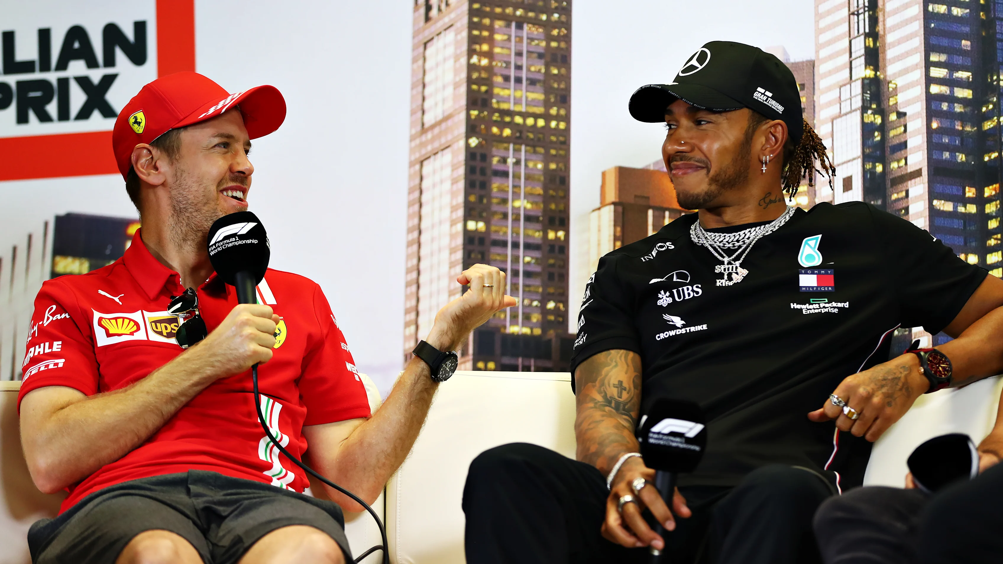 MELBOURNE, AUSTRALIA - MARCH 12: Sebastian Vettel of Germany and Ferrari and Lewis Hamilton of