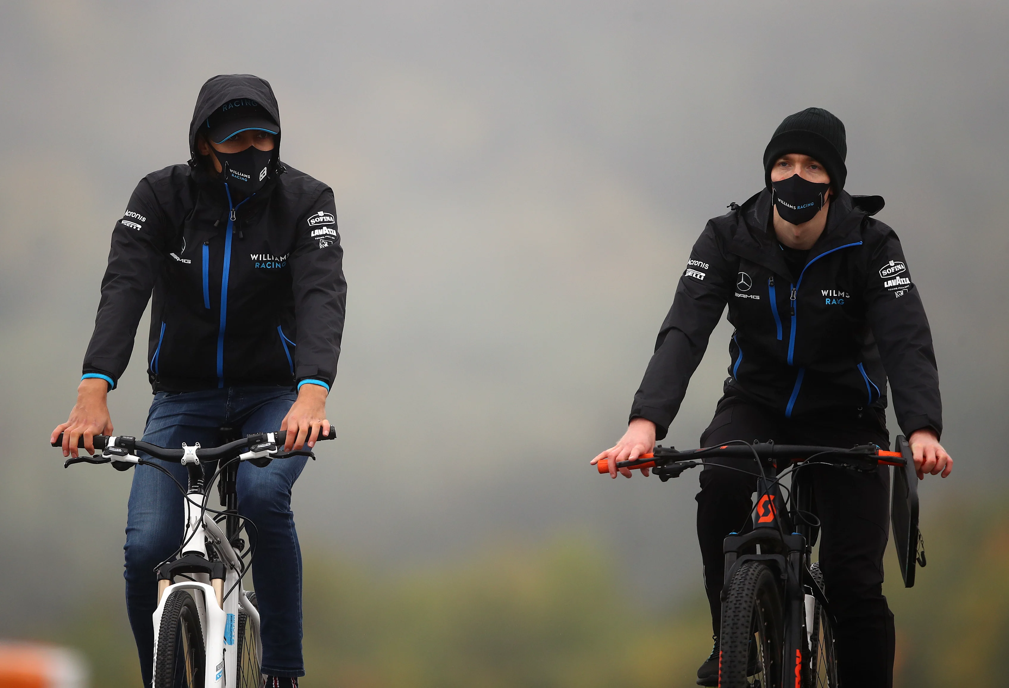 NUERBURG, GERMANY - OCTOBER 08: George Russell of Great Britain and Williams (left) cycles the track during previews ahead of the F1 Eifel Grand Prix at Nuerburgring on October 08, 2020 in Nuerburg, Germany. (Photo by Bryn Lennon/Getty Images)