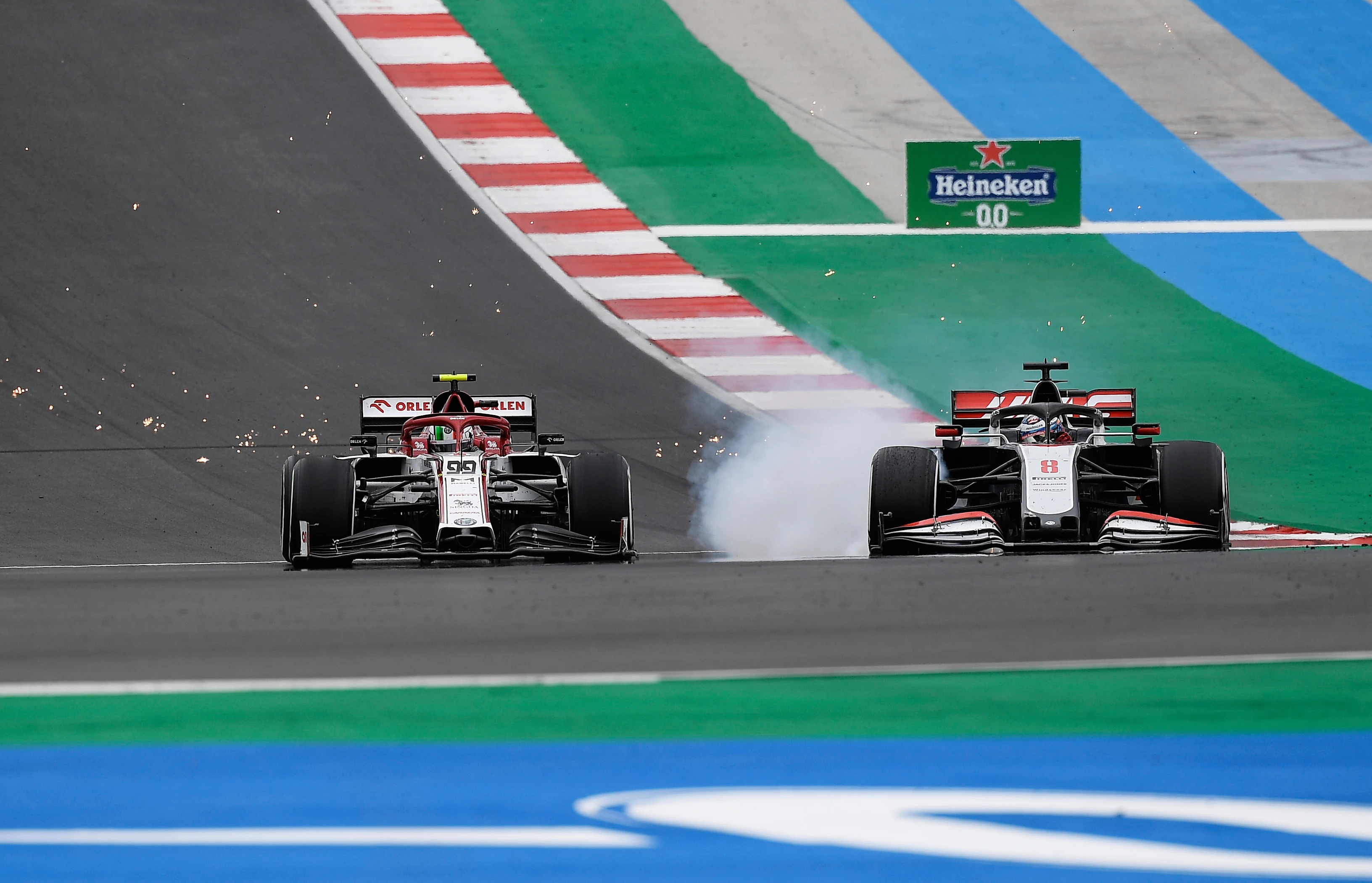 PORTIMAO, PORTUGAL - OCTOBER 25: Antonio Giovinazzi of Italy driving the (99) Alfa Romeo Racing C39 Ferrari and Romain Grosjean of France driving the (8) Haas F1 Team VF-20 Ferrari battle for position on track during the F1 Grand Prix of Portugal at Autodromo Internacional do Algarve on October 25, 2020 in Portimao, Portugal. (Photo by Jorge Guerrero - Pool/Getty Images)