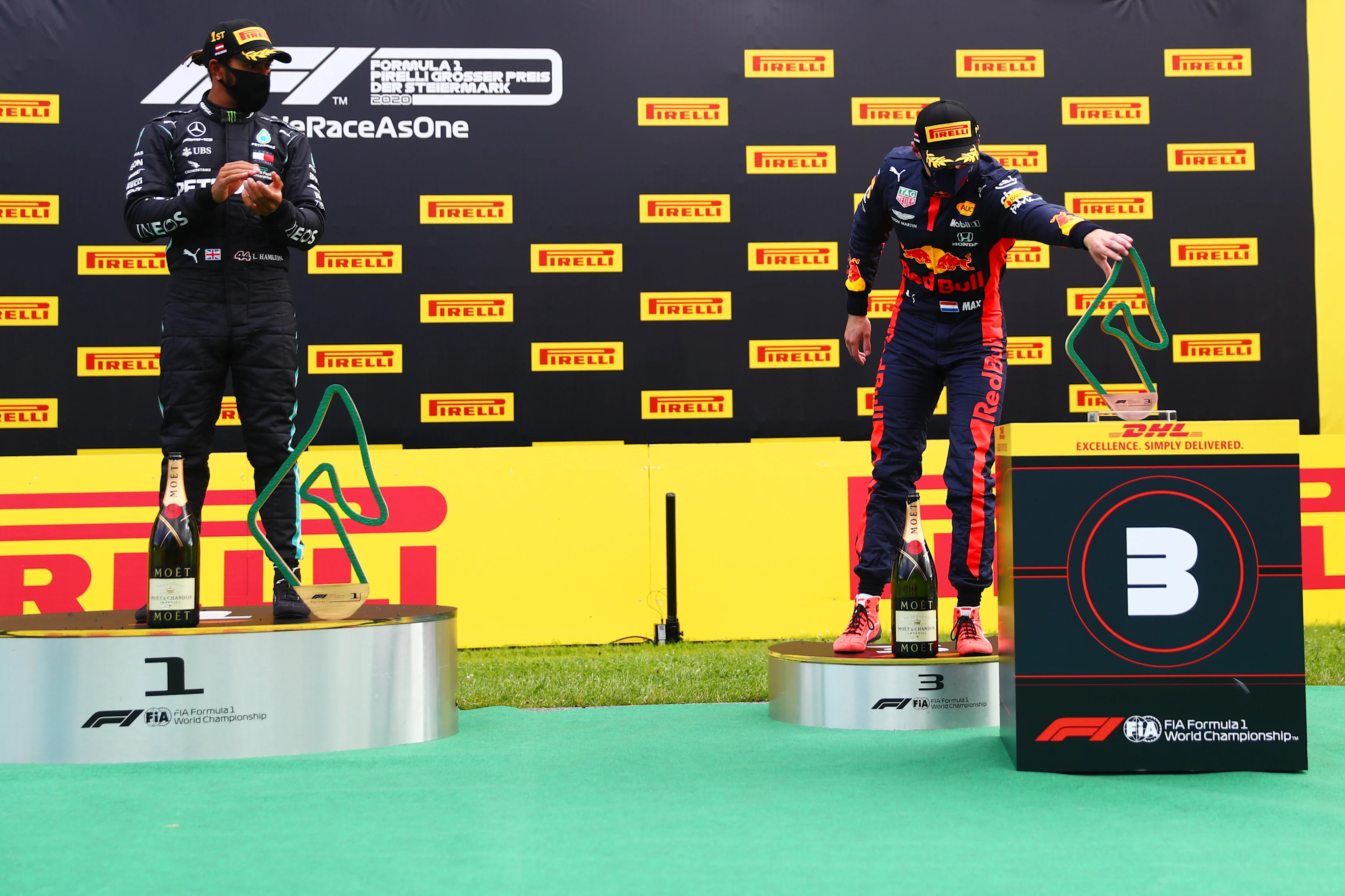 SPIELBERG, AUSTRIA - JULY 12: Max Verstappen of Netherlands and Red Bull Racing reaches to collect
