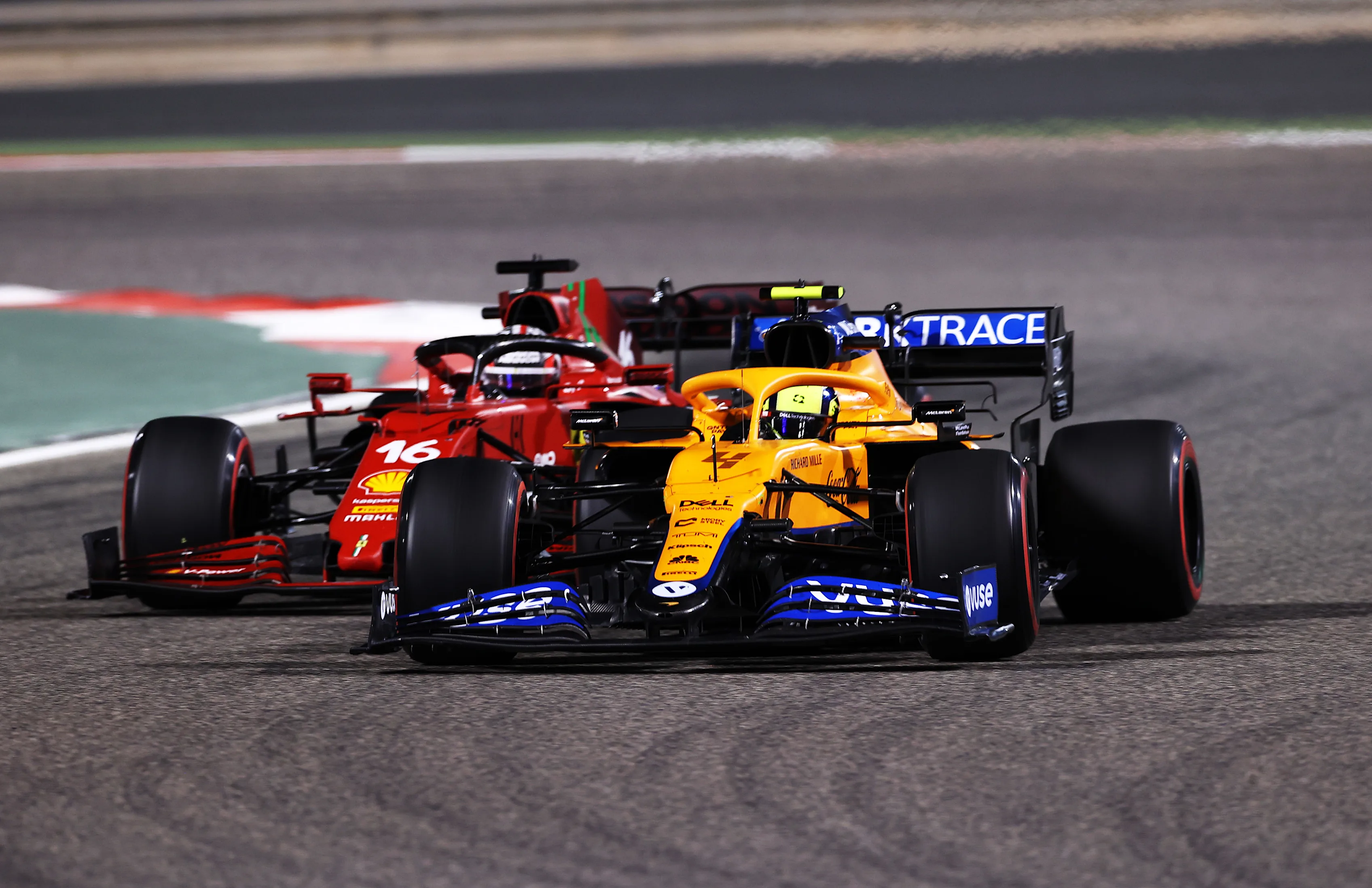 BAHRAIN, BAHRAIN - MARCH 28: Lando Norris of Great Britain driving the (4) McLaren F1 Team MCL35M Mercedes leads Charles Leclerc of Monaco driving the (16) Scuderia Ferrari SF21 during the F1 Grand Prix of Bahrain at Bahrain International Circuit on March 28, 2021 in Bahrain, Bahrain. (Photo by Lars Baron/Getty Images)
