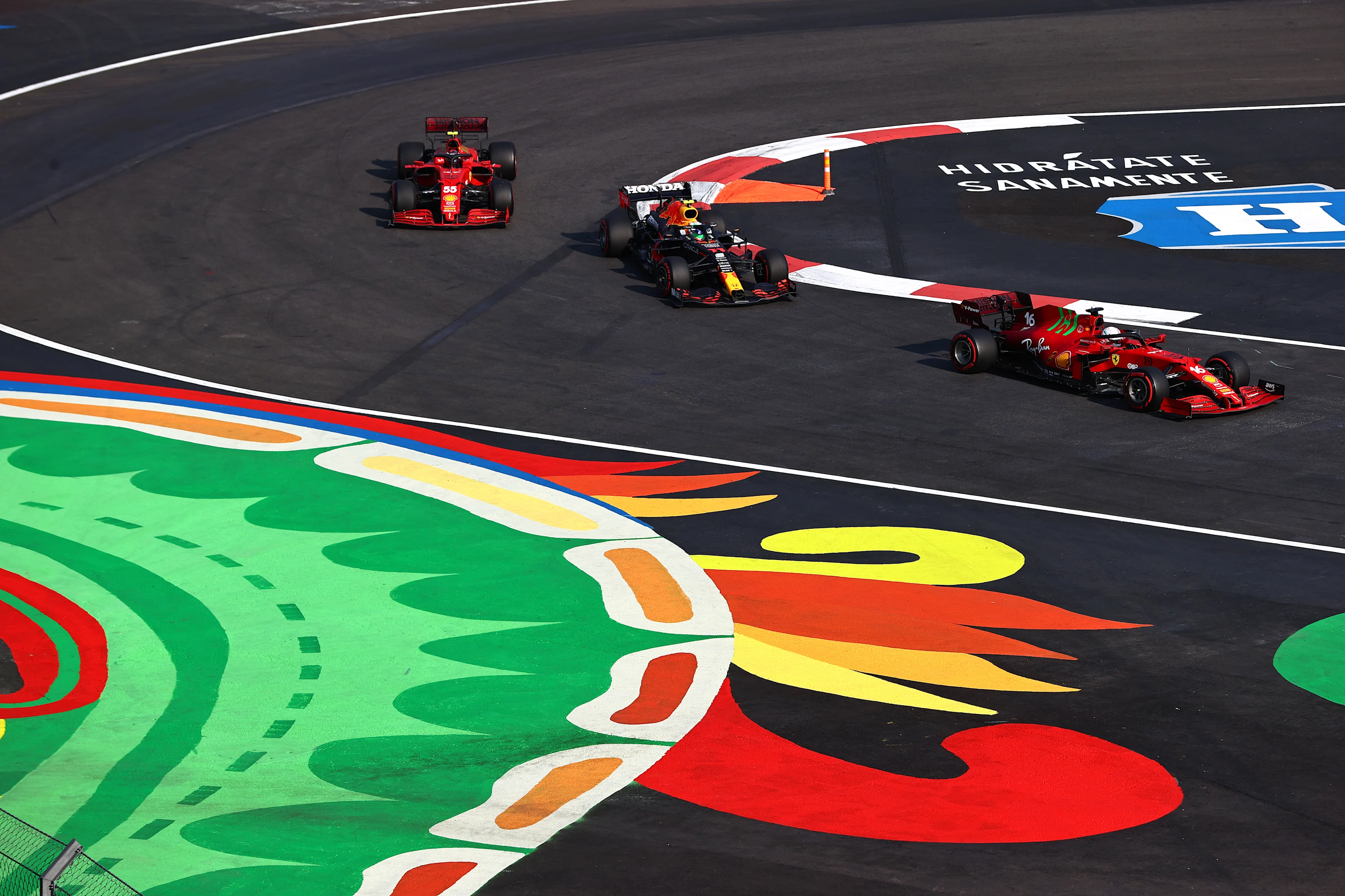 MEXICO CITY, MEXICO - NOVEMBER 05: Charles Leclerc of Monaco driving the (16) Scuderia Ferrari SF21 leads Sergio Perez of Mexico driving the (11) Red Bull Racing RB16B Honda and Carlos Sainz of Spain driving the (55) Scuderia Ferrari SF21 during practice ahead of the F1 Grand Prix of Mexico at Autodromo Hermanos Rodriguez on November 05, 2021 in Mexico City, Mexico. (Photo by Mark Thompson/Getty Images)