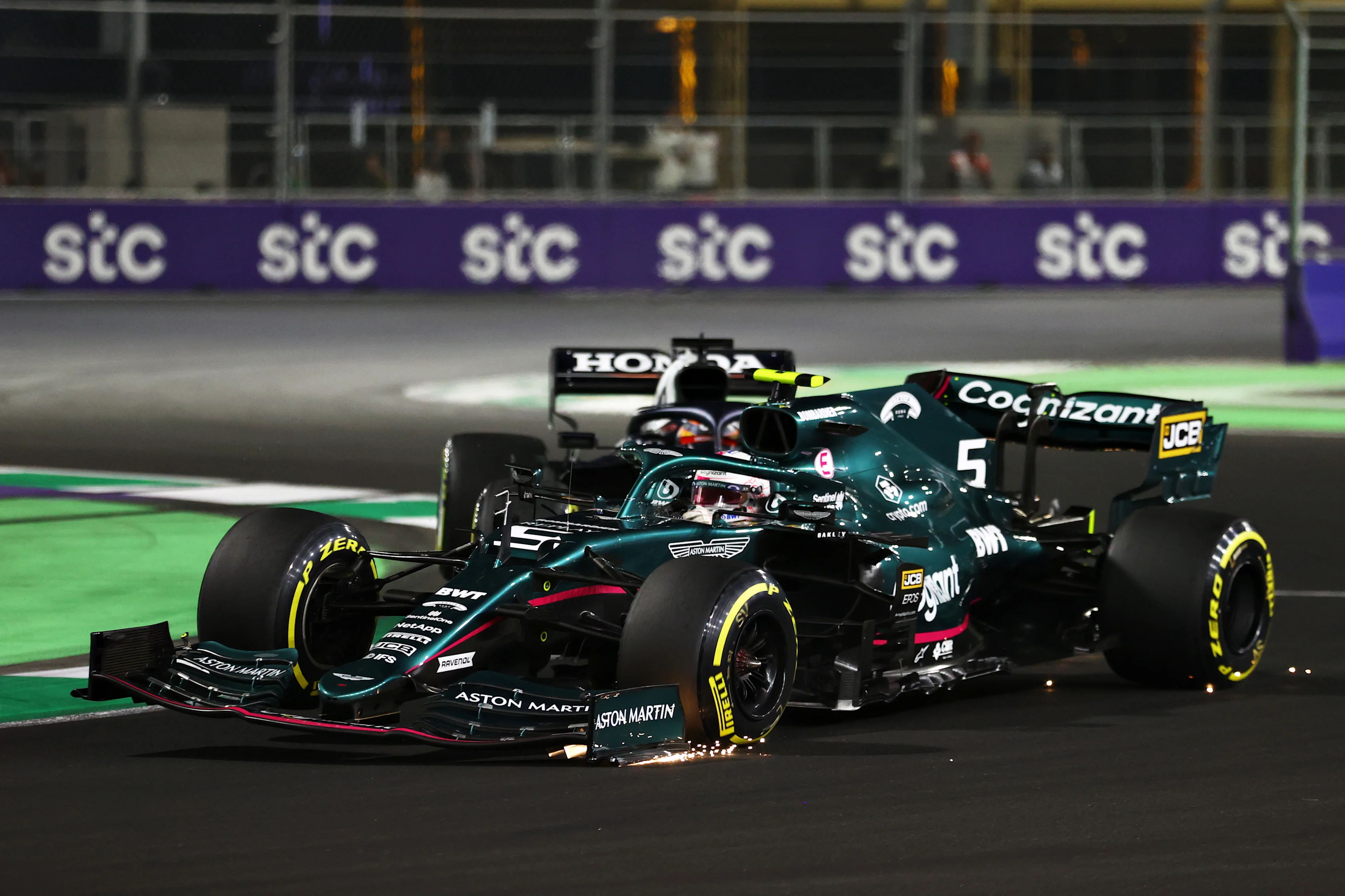 JEDDAH, SAUDI ARABIA - DECEMBER 05: Sebastian Vettel of Germany driving the (5) Aston Martin AMR21 Mercedes and Yuki Tsunoda of Japan driving the (22) Scuderia AlphaTauri AT02 Honda collide during the F1 Grand Prix of Saudi Arabia at Jeddah Corniche Circuit on December 05, 2021 in Jeddah, Saudi Arabia. (Photo by Bryn Lennon - Formula 1/Formula 1 via Getty Images)
