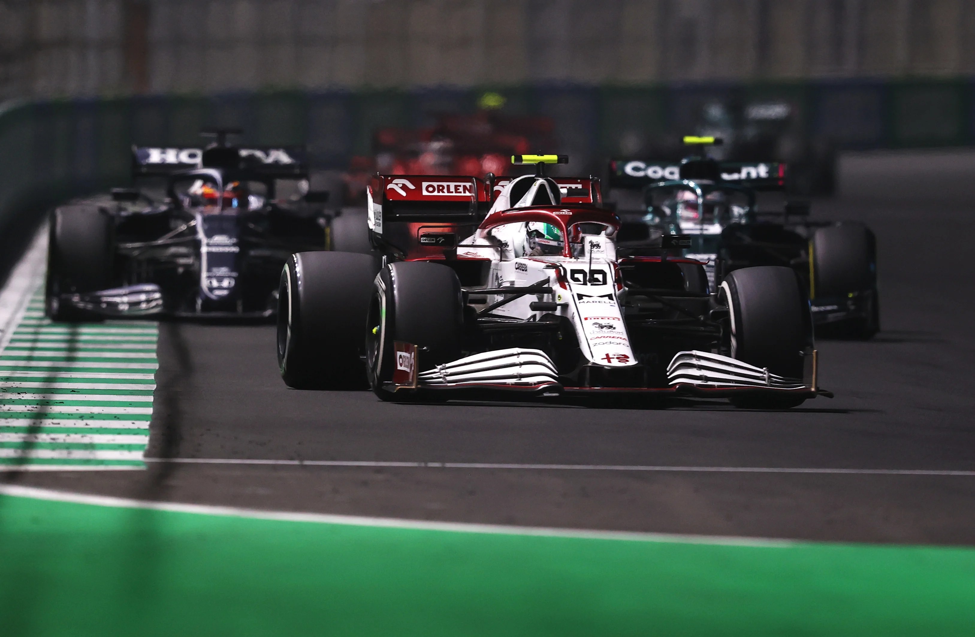 JEDDAH, SAUDI ARABIA - DECEMBER 05: Antonio Giovinazzi of Italy driving the (99) Alfa Romeo Racing C41 Ferrari leads Yuki Tsunoda of Japan driving the (22) Scuderia AlphaTauri AT02 Honda during the F1 Grand Prix of Saudi Arabia at Jeddah Corniche Circuit on December 05, 2021 in Jeddah, Saudi Arabia. (Photo by Lars Baron/Getty Images)