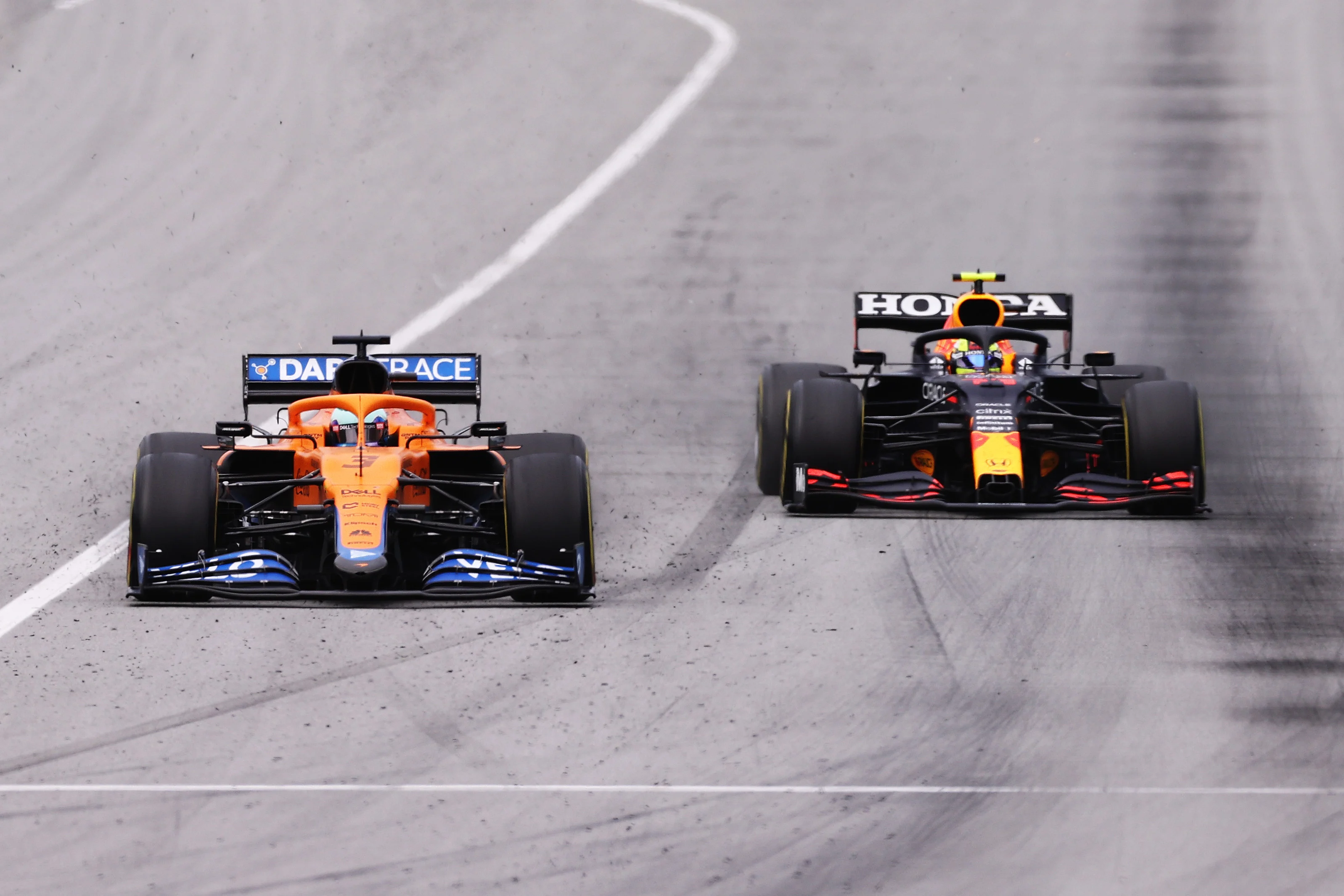 BARCELONA, SPAIN - MAY 09: Daniel Ricciardo of Australia driving the (3) McLaren F1 Team MCL35M Mercedes and Sergio Perez of Mexico driving the (11) Red Bull Racing RB16B Honda on track during the F1 Grand Prix of Spain at Circuit de Barcelona-Catalunya on May 09, 2021 in Barcelona, Spain. (Photo by Lars Baron/Getty Images)