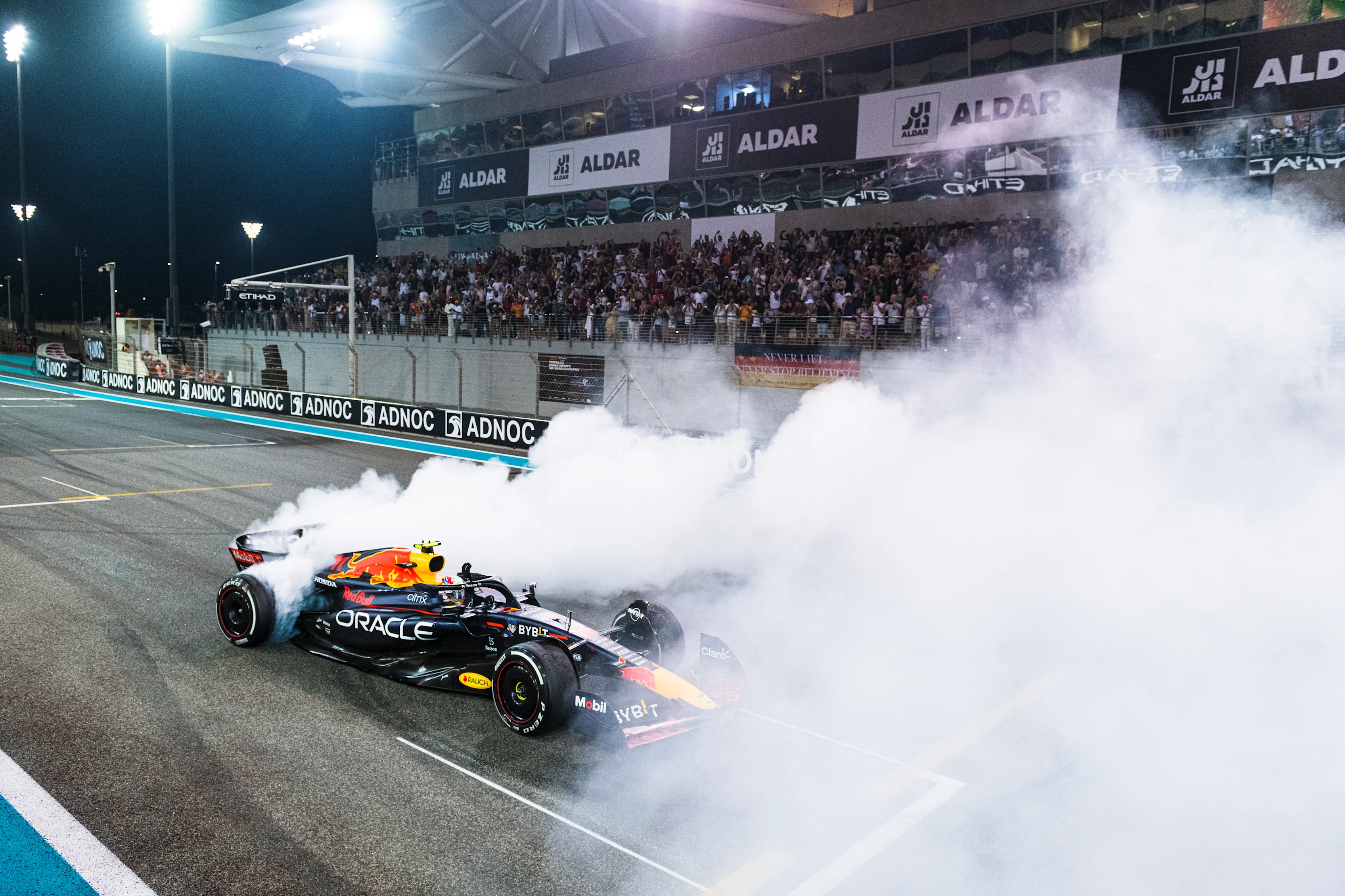 ABU DHABI, UNITED ARAB EMIRATES - NOVEMBER 20: Third placed Sergio Perez of Mexico and Oracle Red