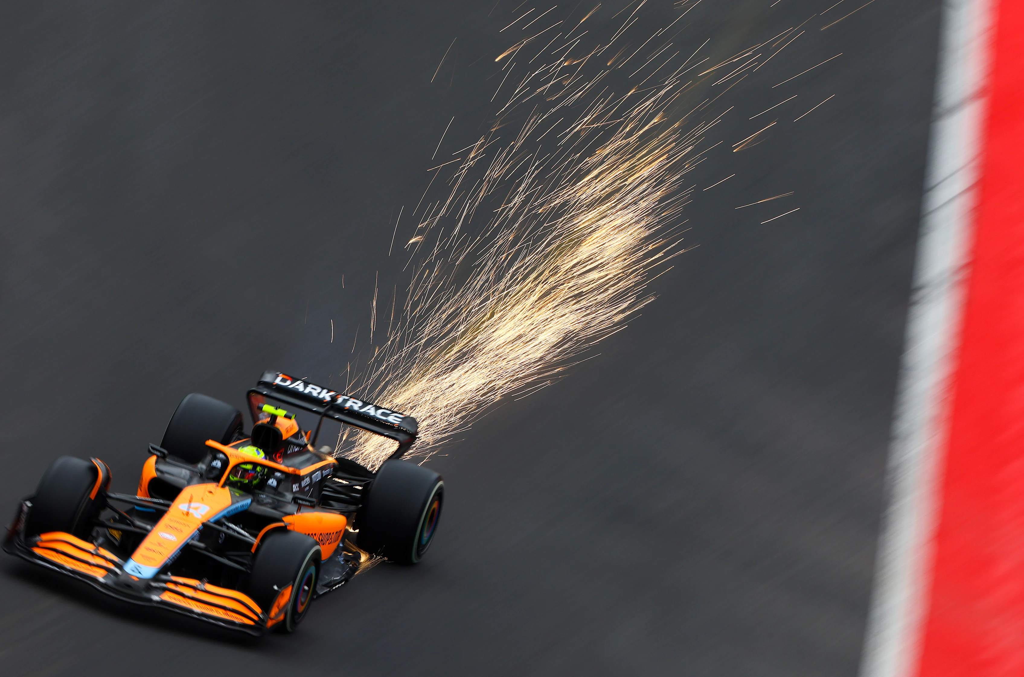 SPA, BELGIUM - AUGUST 27: Sparks fly behind Lando Norris of Great Britain driving the (4) McLaren