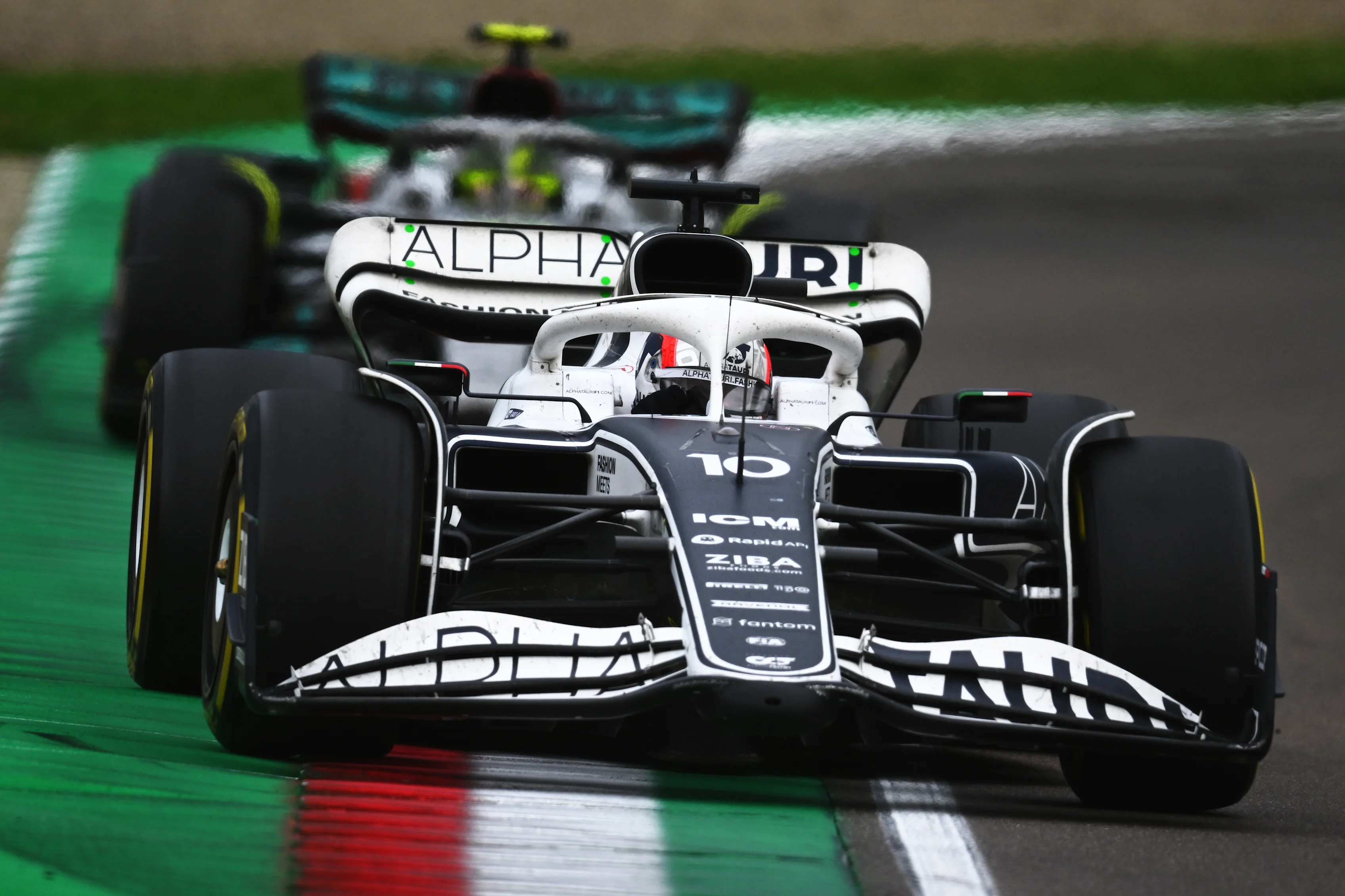 IMOLA, ITALY - APRIL 24: Pierre Gasly of France driving the (10) Scuderia AlphaTauri AT03 leads Lewis Hamilton of Great Britain driving the (44) Mercedes AMG Petronas F1 Team W13 during the F1 Grand Prix of Emilia Romagna at Autodromo Enzo e Dino Ferrari on April 24, 2022 in Imola, Italy. (Photo by Clive Mason/Getty Images)