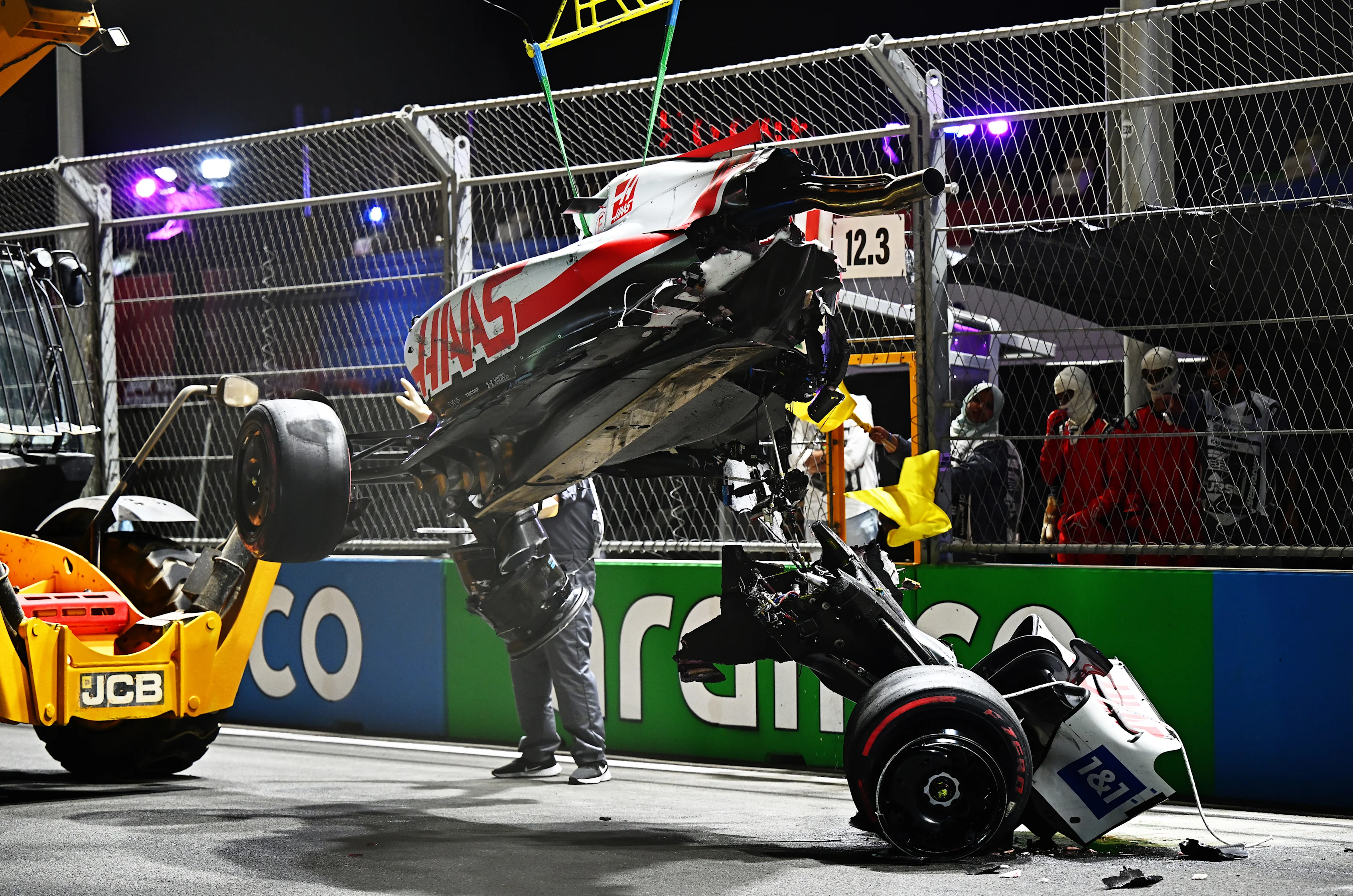 JEDDAH, SAUDI ARABIA - MARCH 26: Track marshals clean debris from the track following the crash of