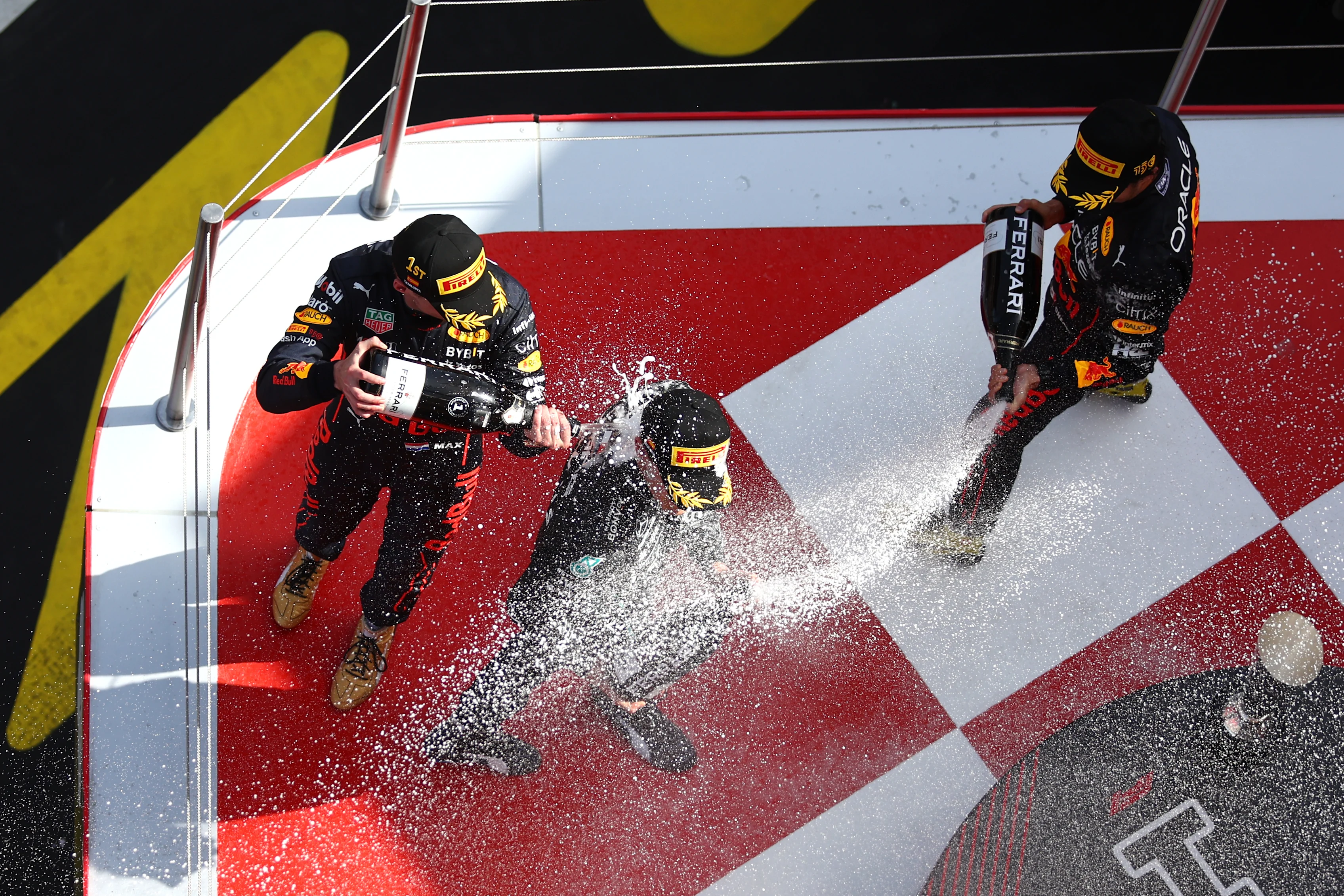 BARCELONA, SPAIN - MAY 22: Race winner Max Verstappen of the Netherlands and Oracle Red Bull Racing, Second placed Sergio Perez of Mexico and Oracle Red Bull Racing and Third placed George Russell of Great Britain and Mercedes celebrate on the podium during the F1 Grand Prix of Spain at Circuit de Barcelona-Catalunya on May 22, 2022 in Barcelona, Spain. (Photo by Lars Baron/Getty Images)