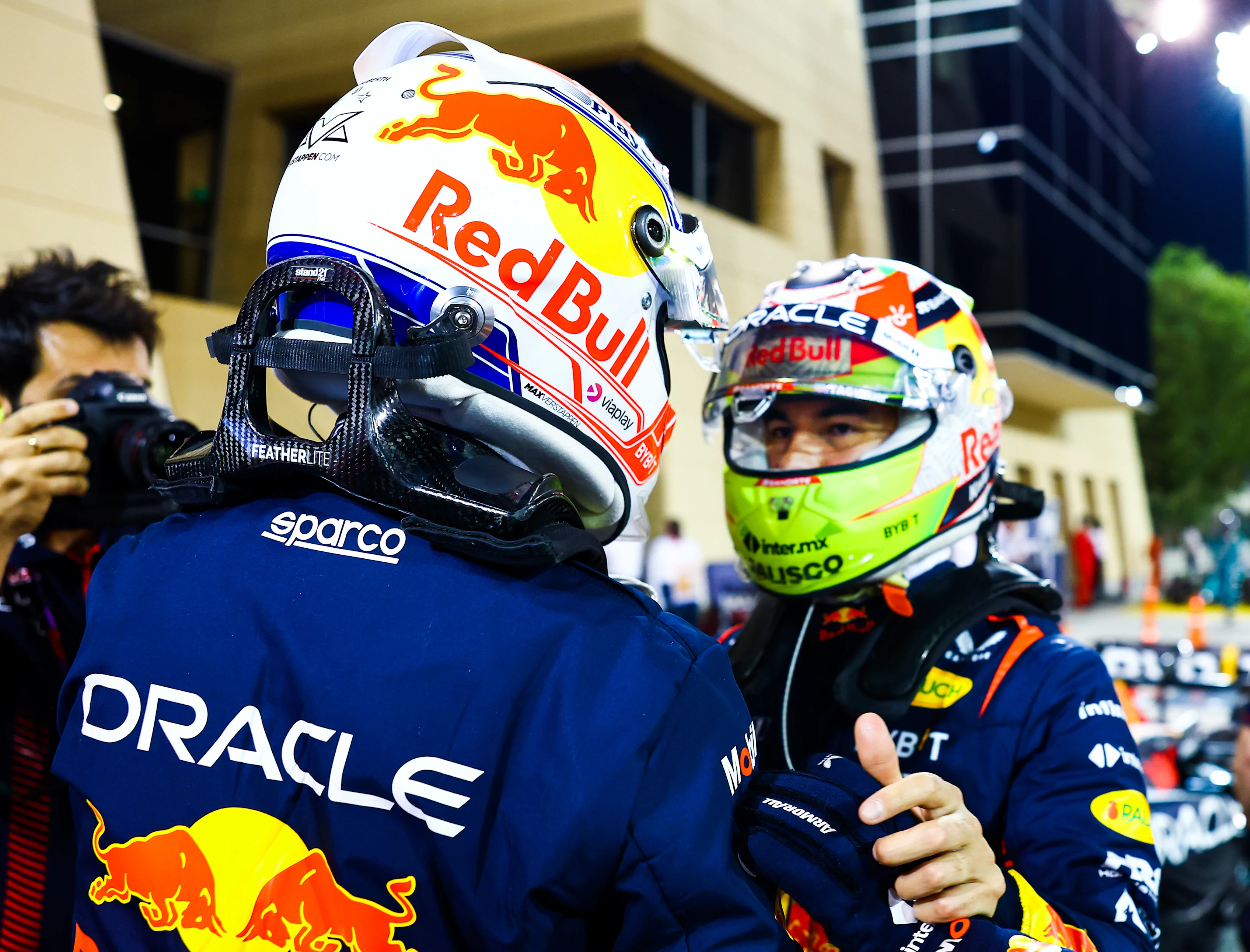 BAHRAIN, BAHRAIN - MARCH 04: Pole position qualifier Max Verstappen of the Netherlands and Oracle Red Bull Racing and Second placed qualifier Sergio Perez of Mexico and Oracle Red Bull Racing talk in parc ferme during qualifying ahead of the F1 Grand Prix of Bahrain at Bahrain International Circuit on March 04, 2023 in Bahrain, Bahrain. (Photo by Mark Thompson/Getty Images)