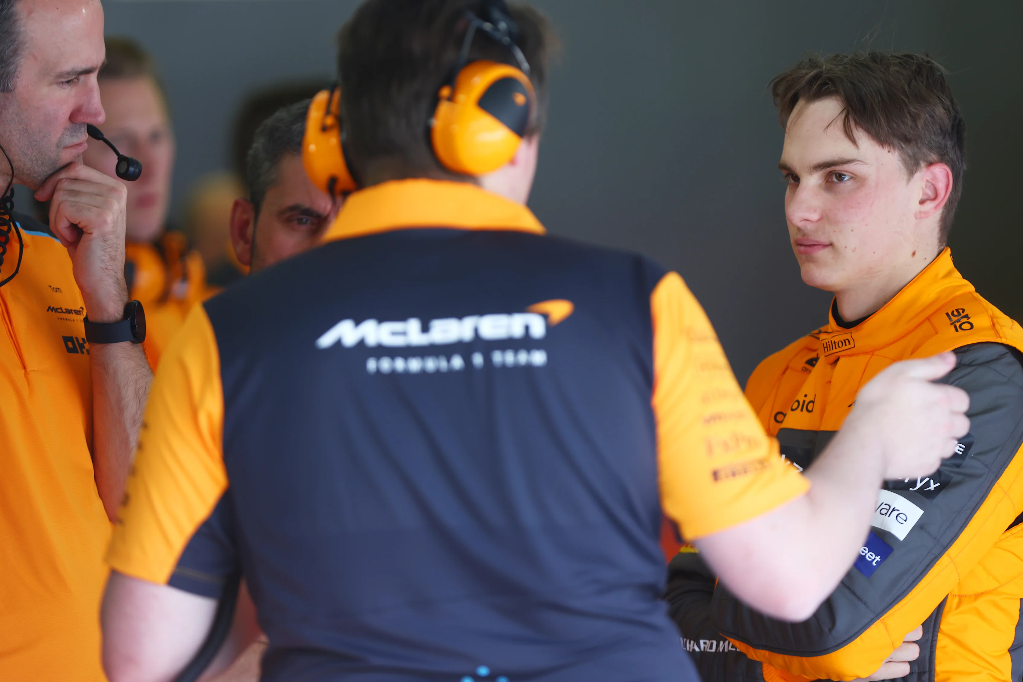 BAHRAIN, BAHRAIN - FEBRUARY 23: Oscar Piastri of Australia and McLaren speaks with members of his