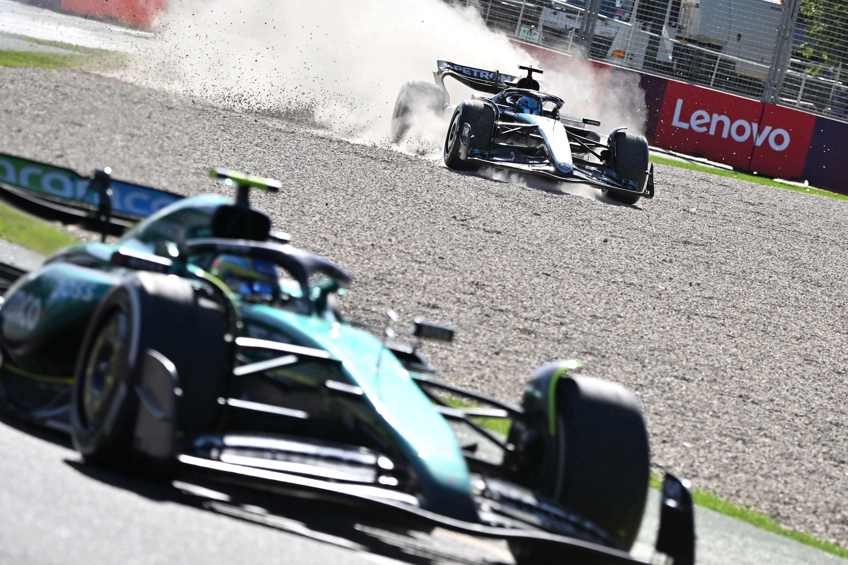 TOPSHOT - Mercedes' British driver George Russell goes off the track behind Aston Martin's Spanish