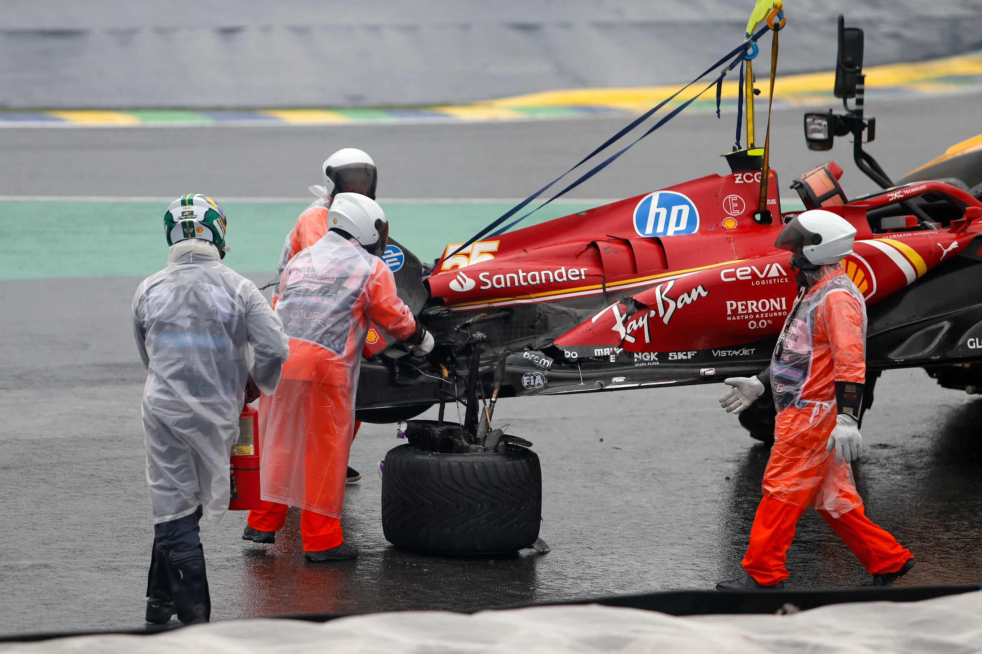 The car of Ferrari's Spanish driver Carlos Sainz is removed from the track after an accident during