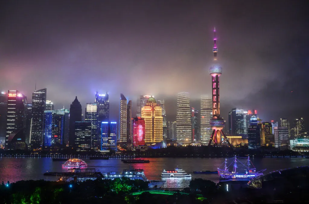 SHANGHAI, CHINA - AUGUST 28: Boats travel on the Huangpu River as the skyline of the city is is