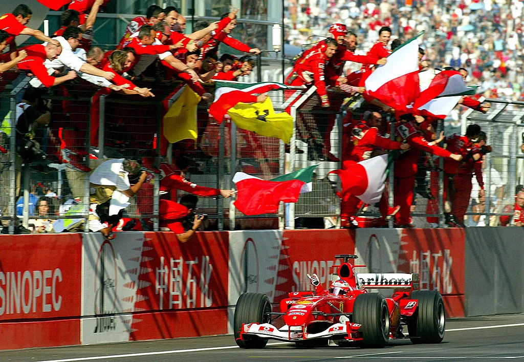 SHANGHAI, CHINA: Ferrari's driver Rubens Barrichello of Brazil waves to his Ferrari's crew as they