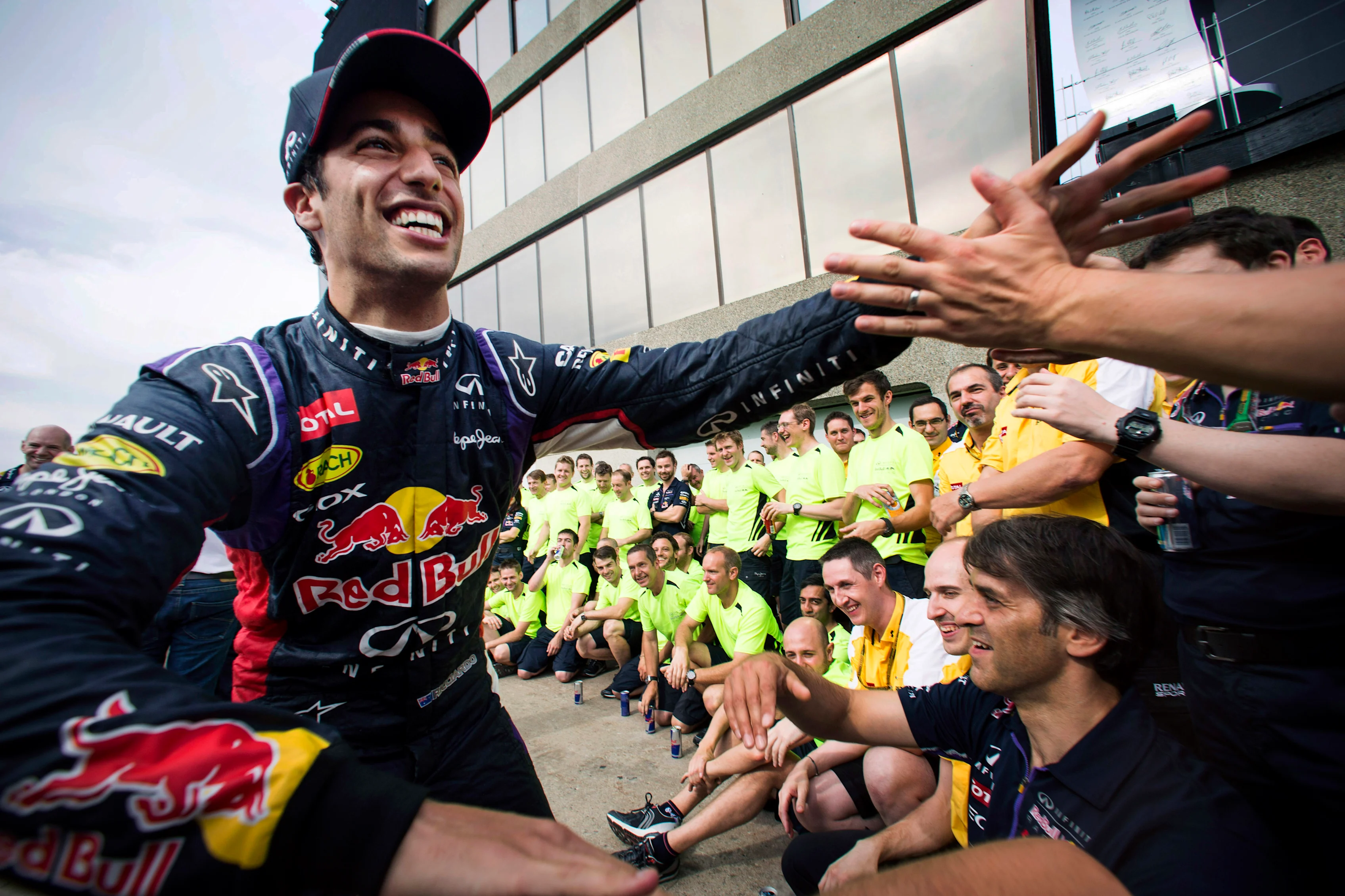 Smiling Australian Red Bull Racing Formula One racing team racing driver Daniel Ricciardo giving