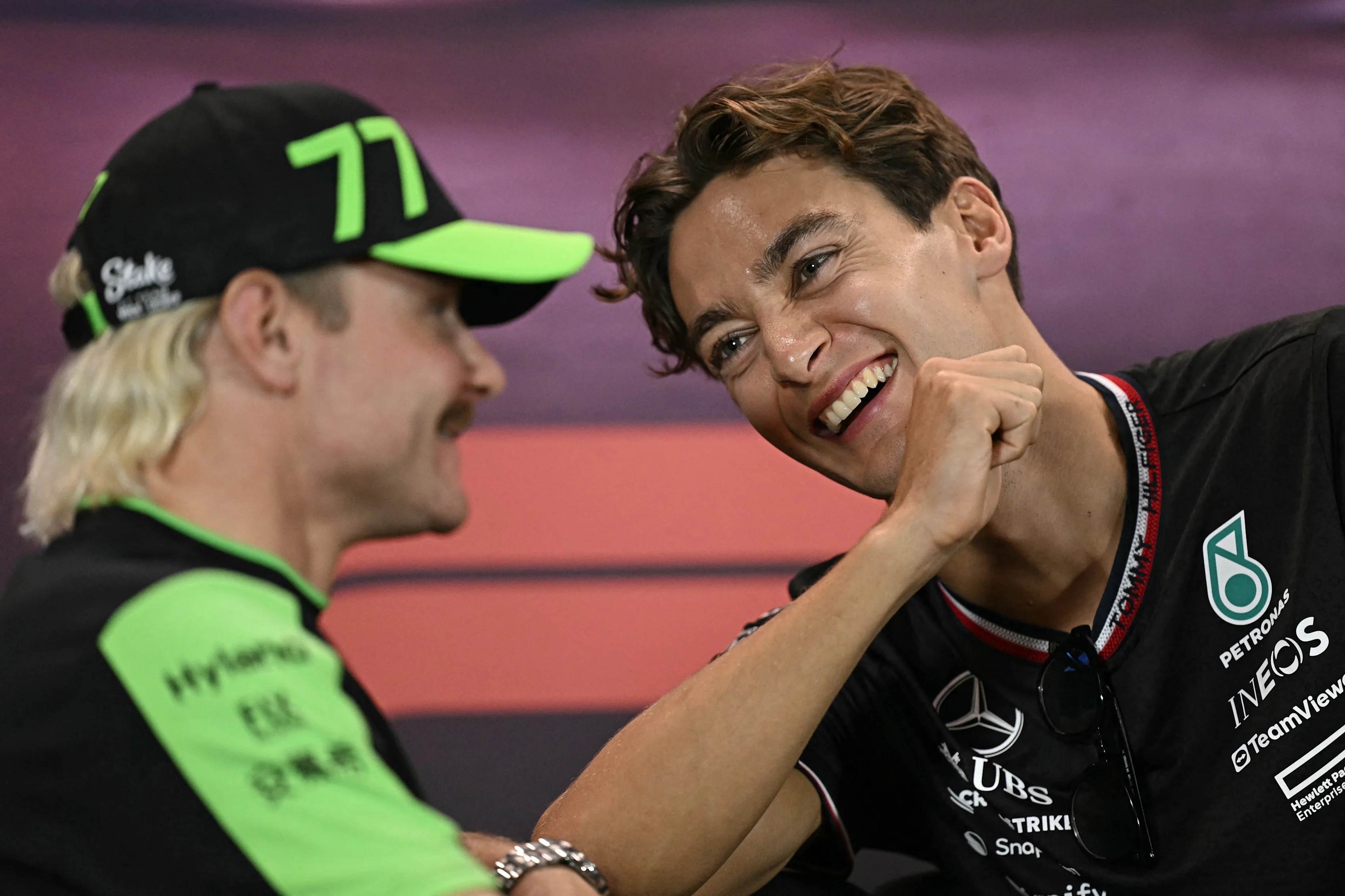 Kick Sauber's Finnish driver Valtteri Bottas (L) and Mercedes' British driver George Russell take part in a press conference ahead of the Formula One Singapore Grand Prix night race at the Marina Bay Street Circuit in Singapore on September 19, 2024. (Photo by Lillian SUWANRUMPHA / AFP) (Photo by LILLIAN SUWANRUMPHA/AFP via Getty Images)
