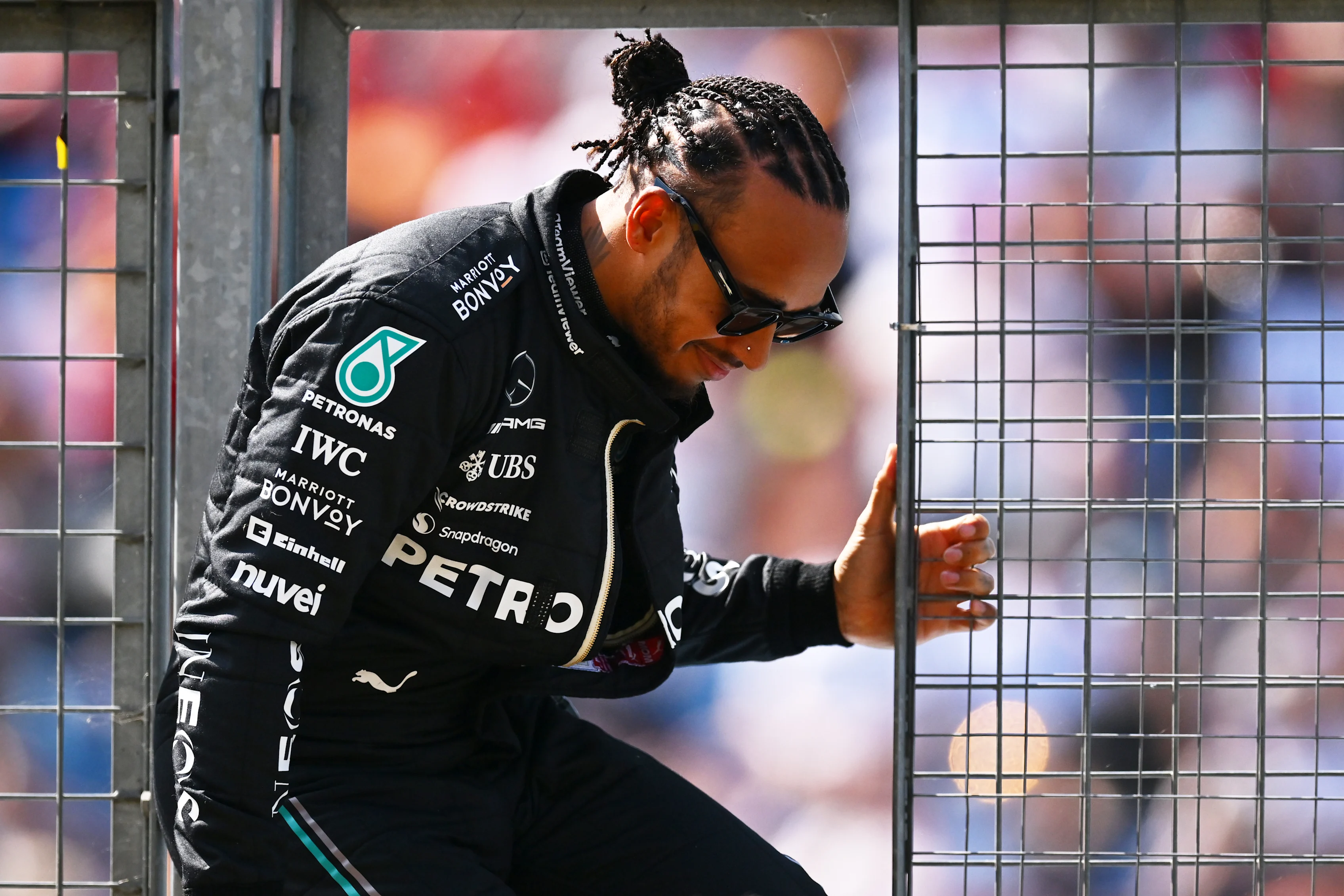 NORTHAMPTON, ENGLAND - JULY 07: Lewis Hamilton of Great Britain and Mercedes climbs through a pit