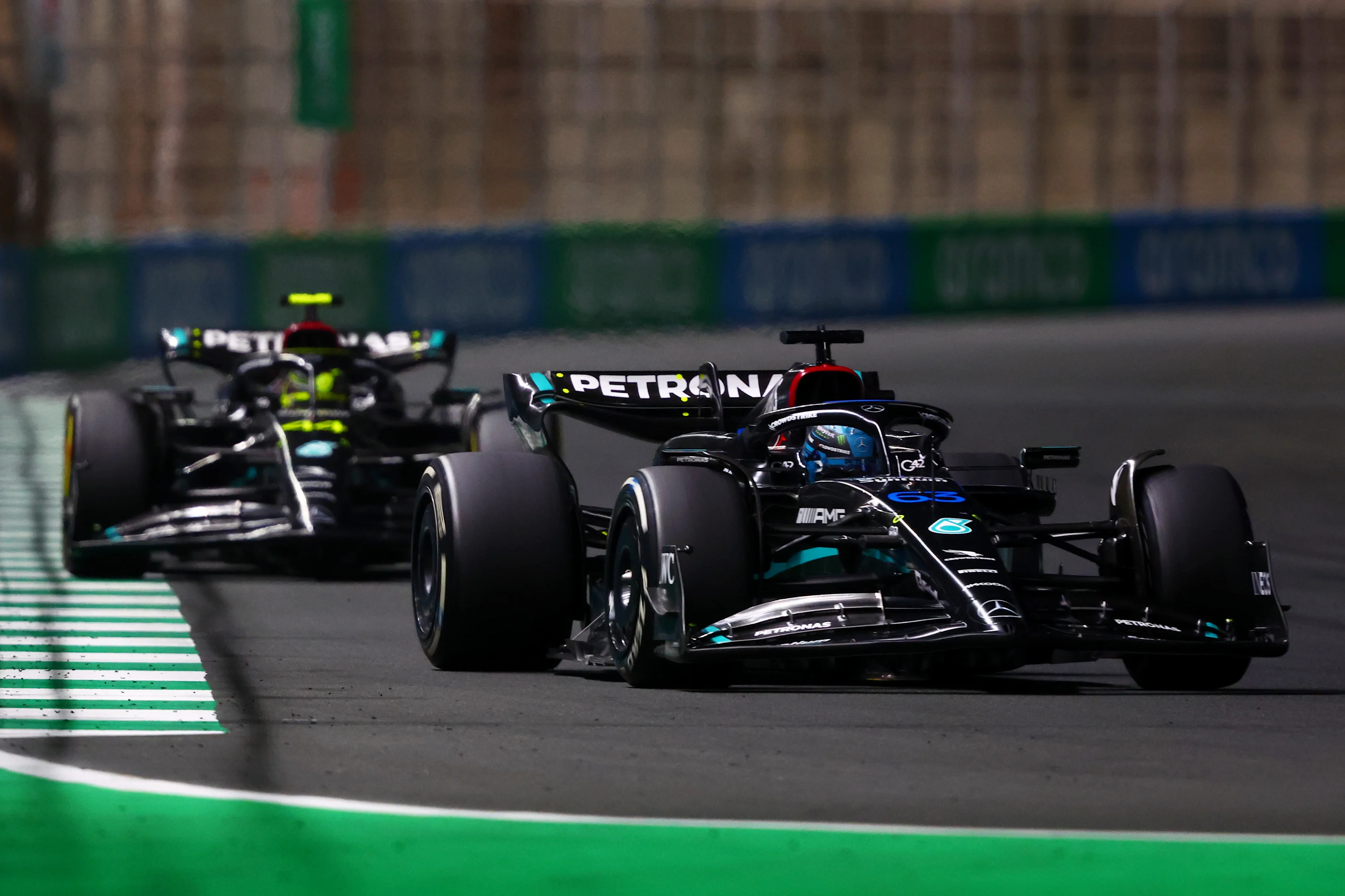 JEDDAH, SAUDI ARABIA - MARCH 19: George Russell of Great Britain driving the (63) Mercedes AMG Petronas F1 Team W14 leads Lewis Hamilton of Great Britain and Mercedes during the F1 Grand Prix of Saudi Arabia at Jeddah Corniche Circuit on March 19, 2023 in Jeddah, Saudi Arabia. (Photo by Bryn Lennon - Formula 1/Formula 1 via Getty Images)