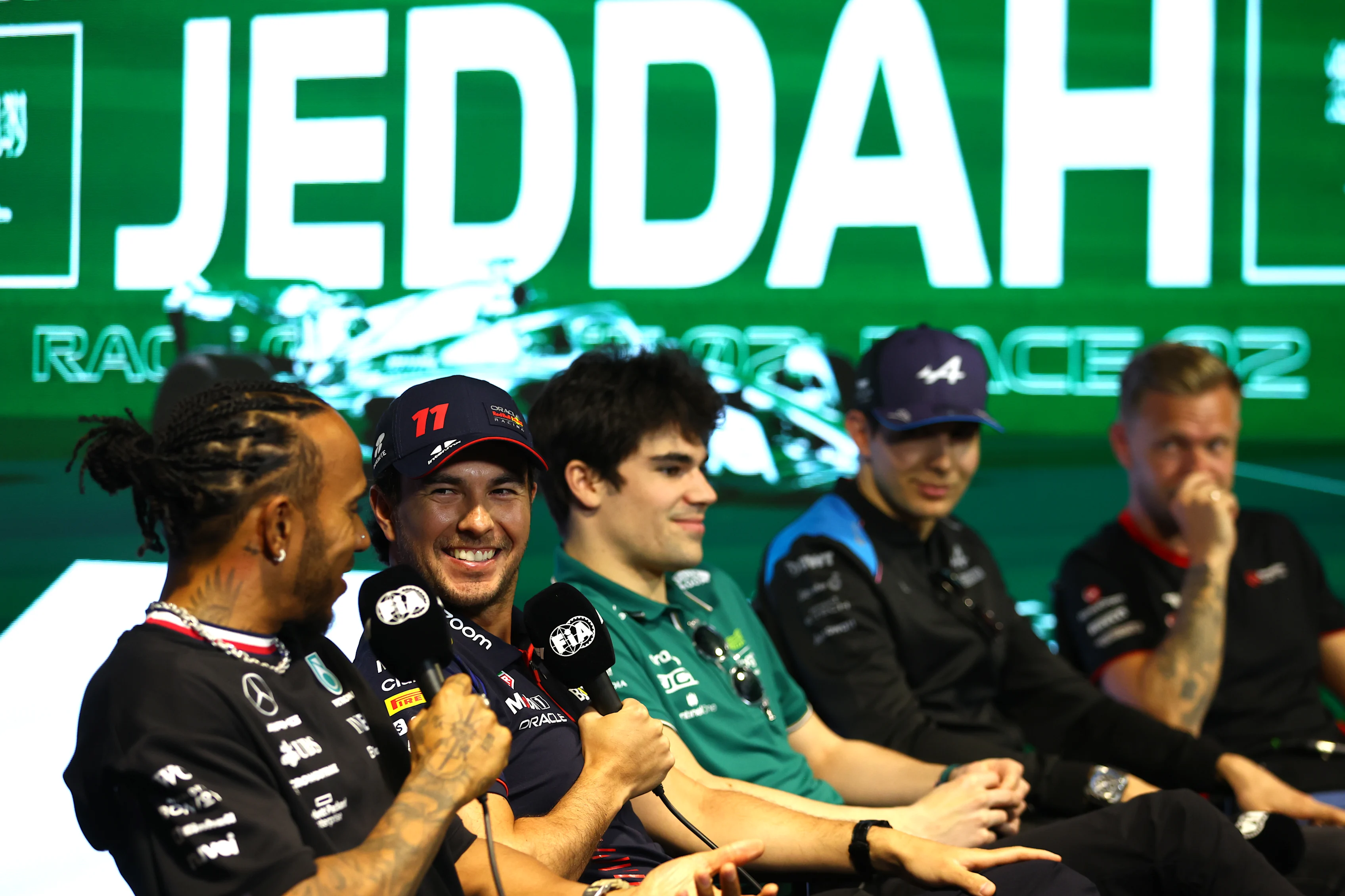 JEDDAH, SAUDI ARABIA - MARCH 16: Sergio Perez of Mexico and Oracle Red Bull Racing talks with Lewis