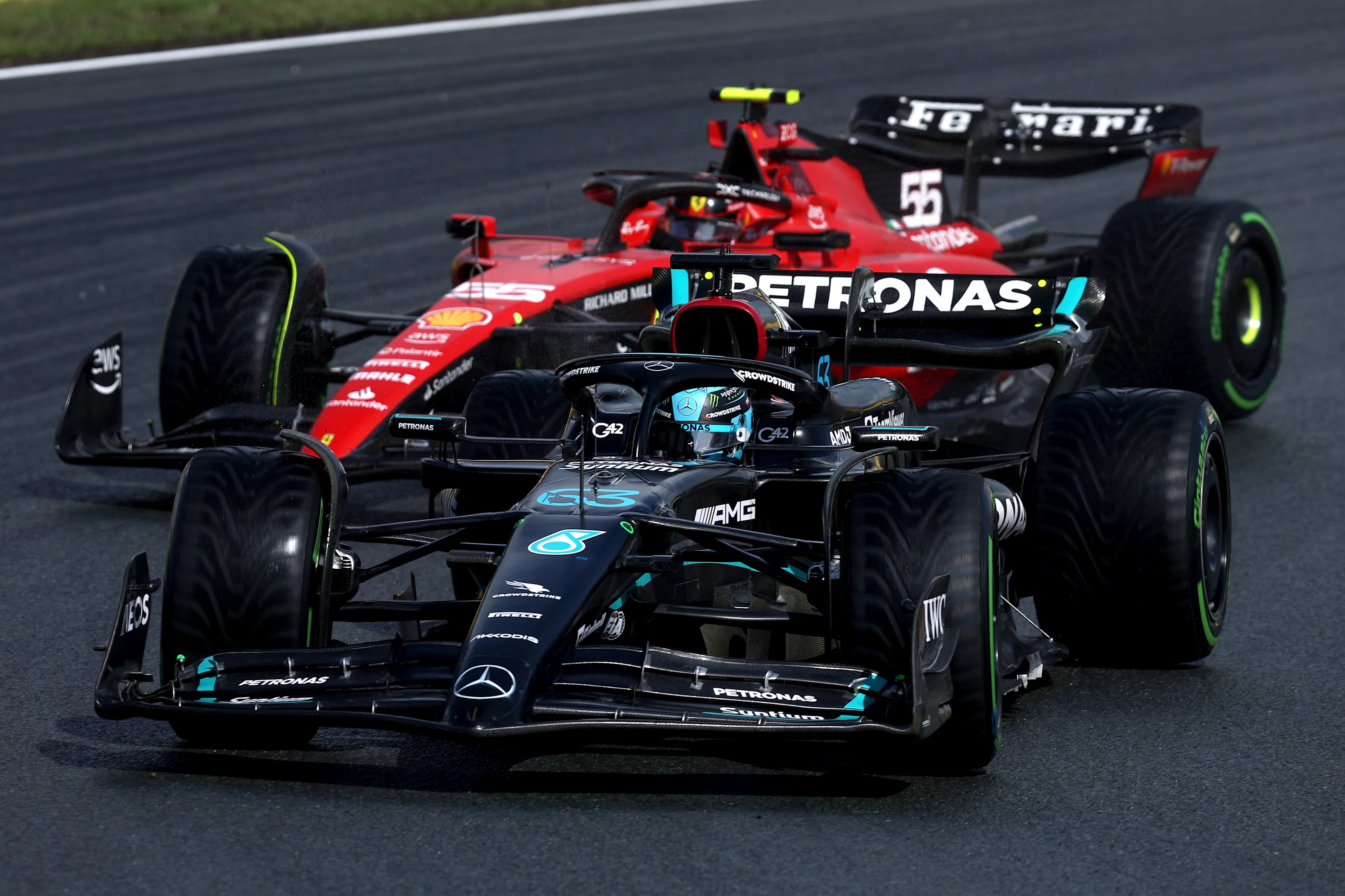 ZANDVOORT, NETHERLANDS - AUGUST 26: George Russell of Great Britain driving the (63) Mercedes AMG Petronas F1 Team W14 leads Carlos Sainz of Spain driving (55) the Ferrari SF-23 on track during qualifying ahead of the F1 Grand Prix of The Netherlands at Circuit Zandvoort on August 26, 2023 in Zandvoort, Netherlands. (Photo by Lars Baron/Getty Images)