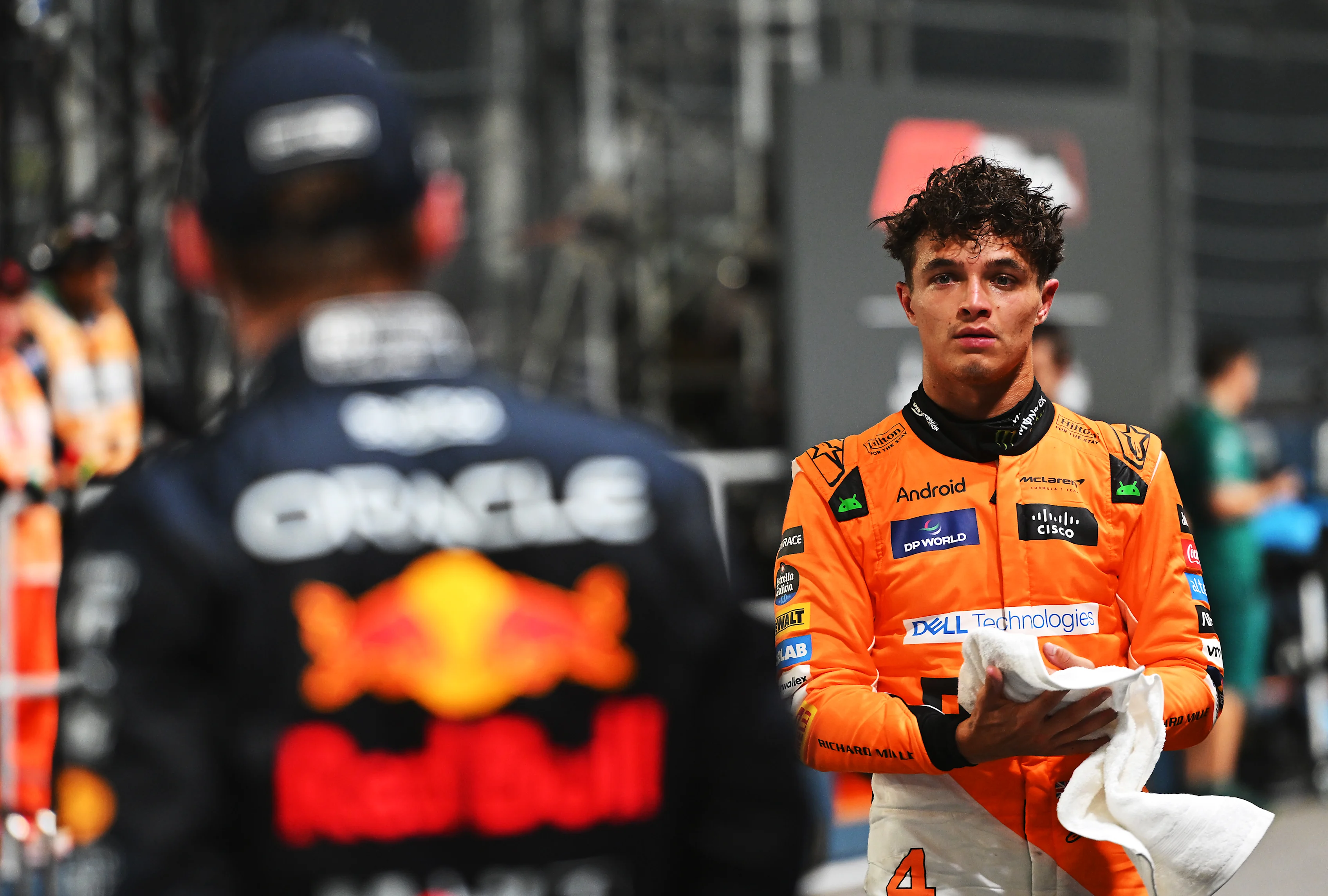 SINGAPORE, SINGAPORE - SEPTEMBER 21: Pole position qualifier Lando Norris of Great Britain and McLaren talks with Second placed qualifier Max Verstappen of the Netherlands and Oracle Red Bull Racing in parc ferme during qualifying ahead of the F1 Grand Prix of Singapore at Marina Bay Street Circuit on September 21, 2024 in Singapore, Singapore. (Photo by Rudy Carezzevoli/Getty Images)