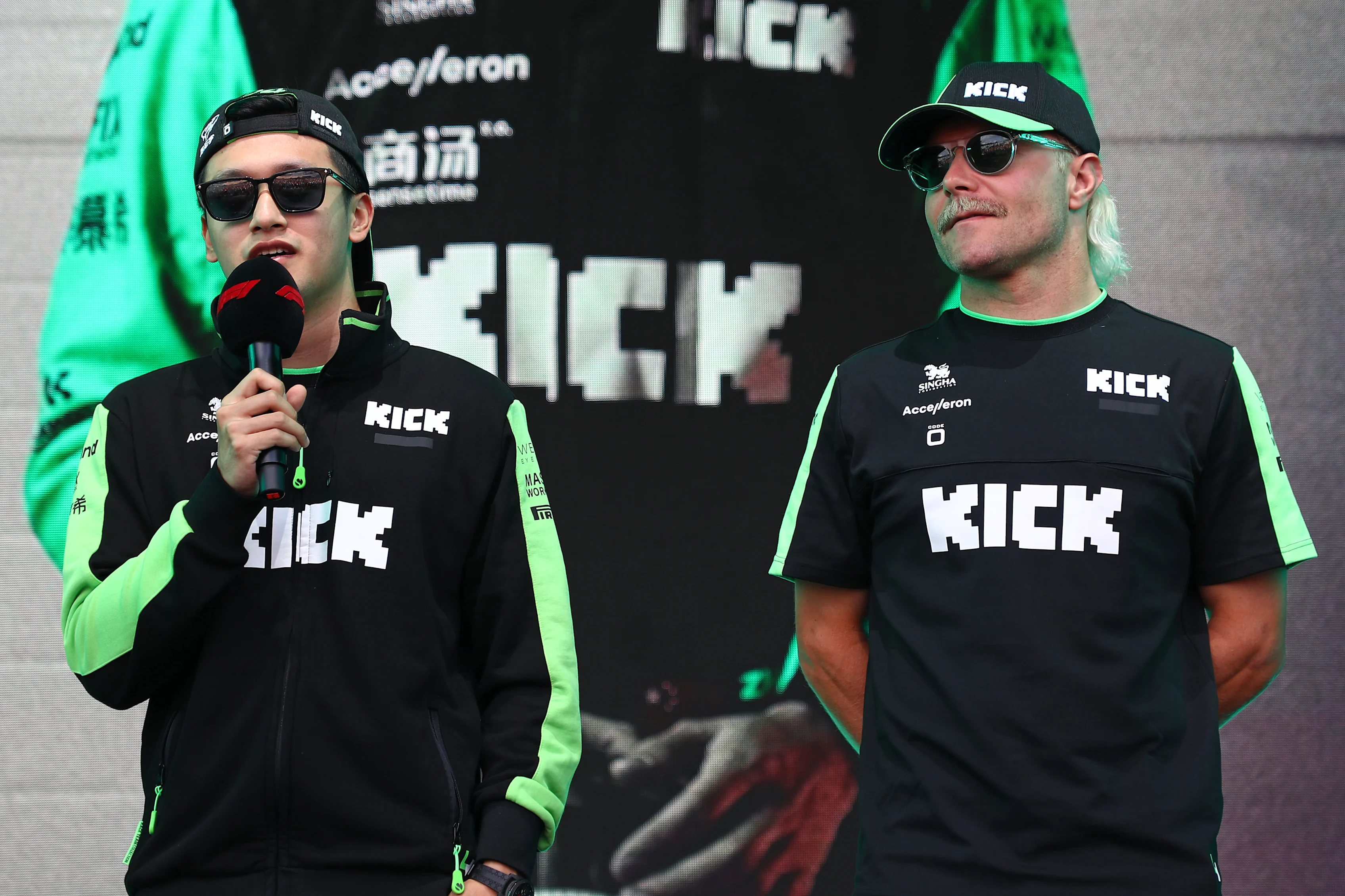 SPA, BELGIUM - JULY 26: Zhou Guanyu of China and Stake F1 Team Kick Sauber and Valtteri Bottas of Finland and Stake F1 Team Kick Sauber talk to the crowd on the fan stage. (Photo by Peter Fox - Formula 1/Formula 1 via Getty Images)
