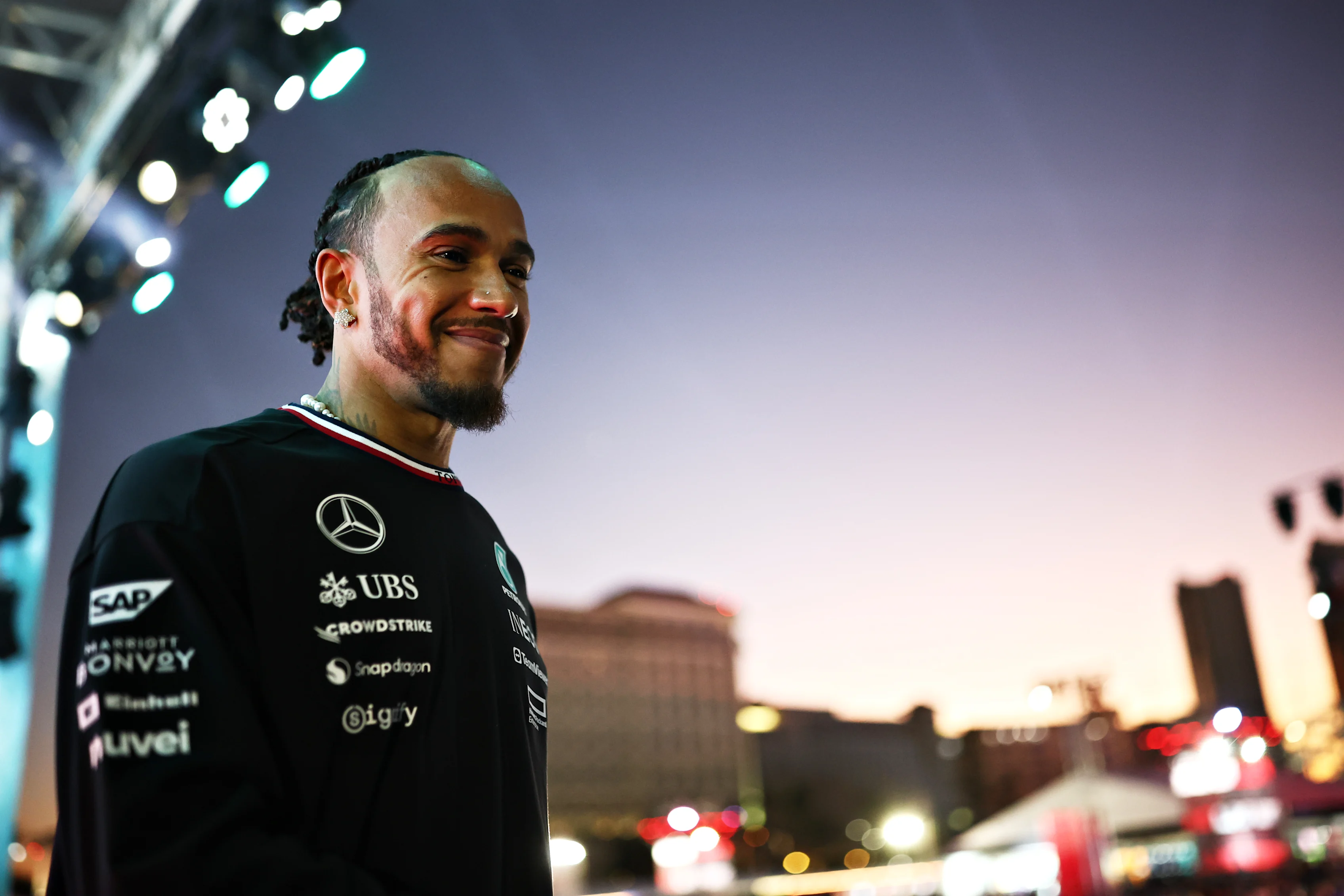 LAS VEGAS, NEVADA - NOVEMBER 21: Lewis Hamilton of Great Britain and Mercedes talks to the crowd on the fan stage prior to practice ahead of the F1 Grand Prix of Las Vegas at Las Vegas Strip Circuit on November 21, 2024 in Las Vegas, Nevada. (Photo by Jared C. Tilton - Formula 1/Formula 1 via Getty Images)