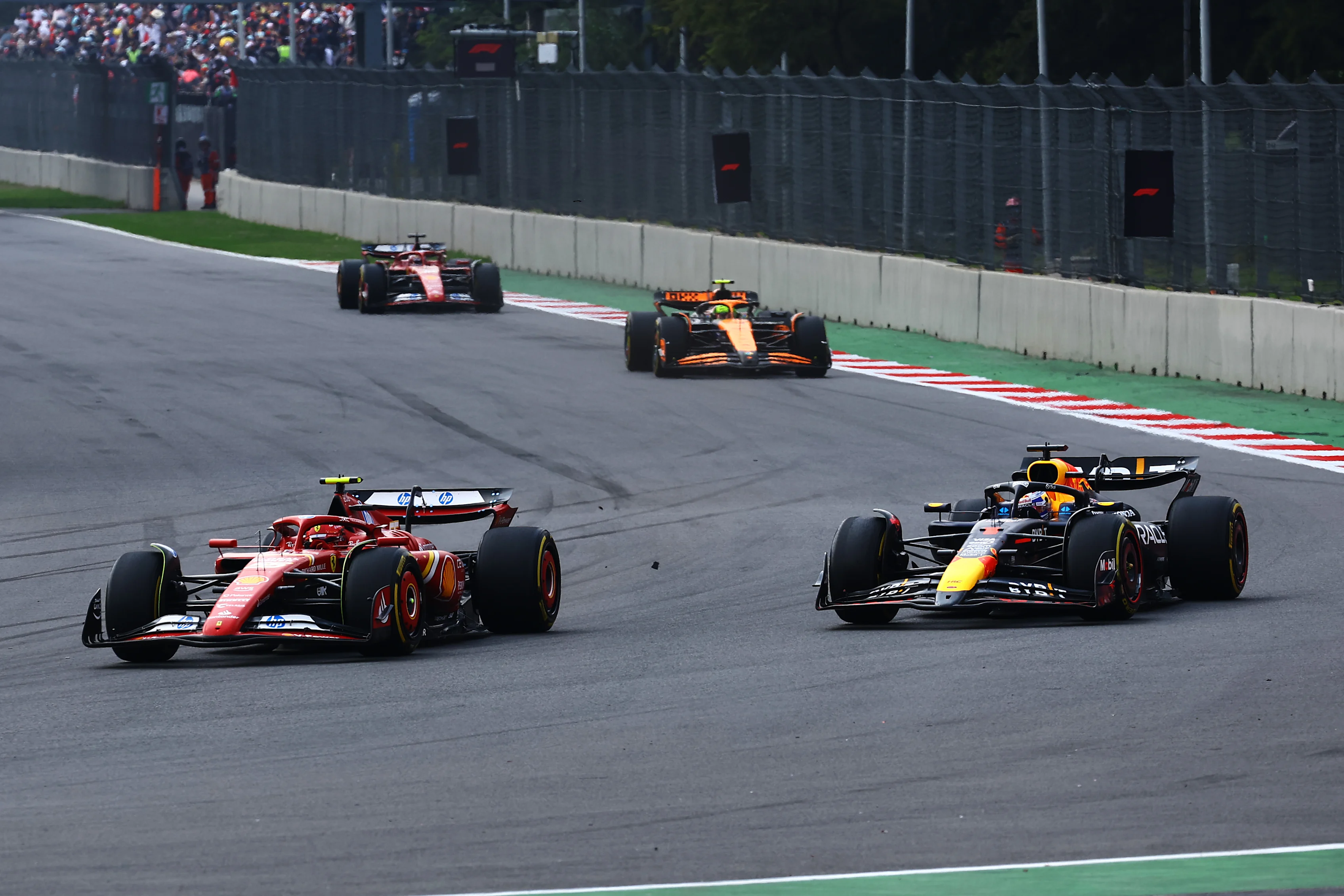 MEXICO CITY, MEXICO - OCTOBER 27: Carlos Sainz of Spain driving (55) the Ferrari SF-24 leads Max Verstappen of the Netherlands driving the (1) Oracle Red Bull Racing RB20 on track during the F1 Grand Prix of Mexico at Autodromo Hermanos Rodriguez on October 27, 2024 in Mexico City, Mexico. (Photo by Mark Thompson/Getty Images)