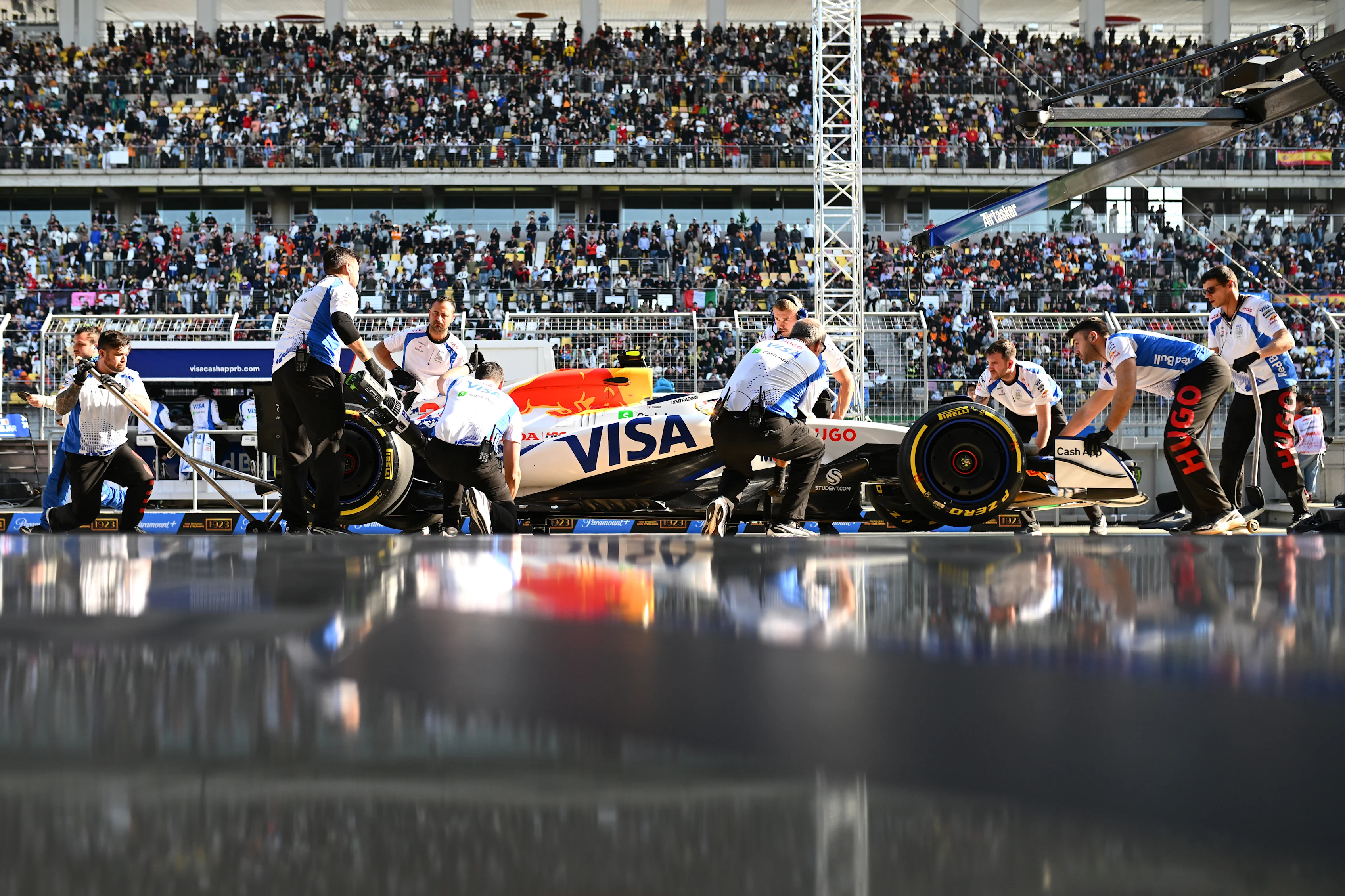 SHANGHAI, CHINA - MARCH 21: Mechanics in the Pitlane with Yuki Tsunoda of Japan driving the (22) Visa Cash App Racing Bulls VCARB 02 during Sprint Qualifying ahead of the F1 Grand Prix of China at Shanghai International Circuit on March 21, 2025 in Shanghai, China. (Photo by Rudy Carezzevoli/Getty Images)