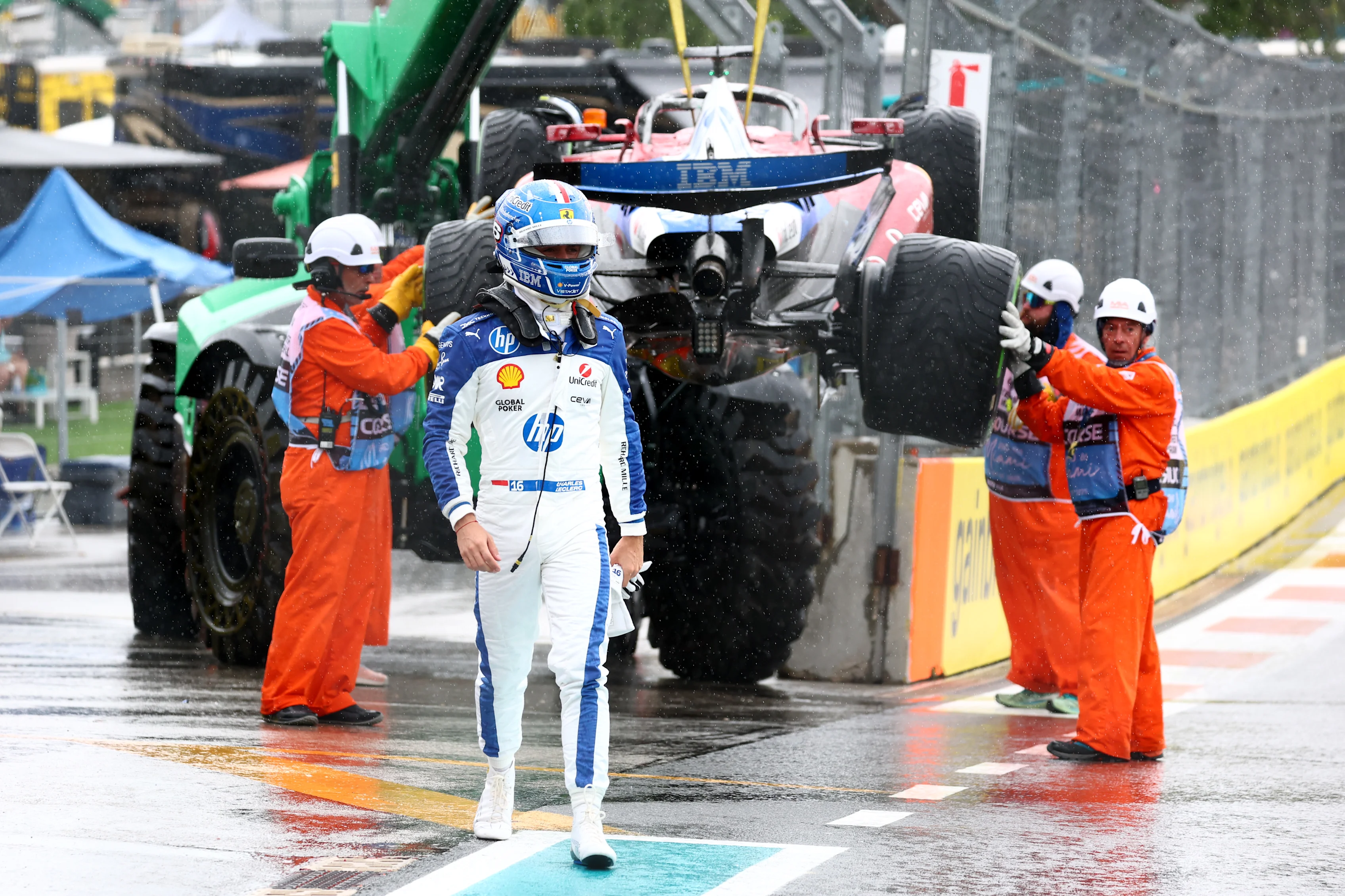 MIAMI, FLORIDA - MAY 03: Marshals remove the car of Charles Leclerc of Monaco driving the (16) Scuderia Ferrari SF-25 from the circuit after a crash on the way to the grid during the Sprint ahead of the F1 Grand Prix of Miami at Miami International Autodrome on May 03, 2025 in Miami, Florida. (Photo by Clive Rose/Getty Images)