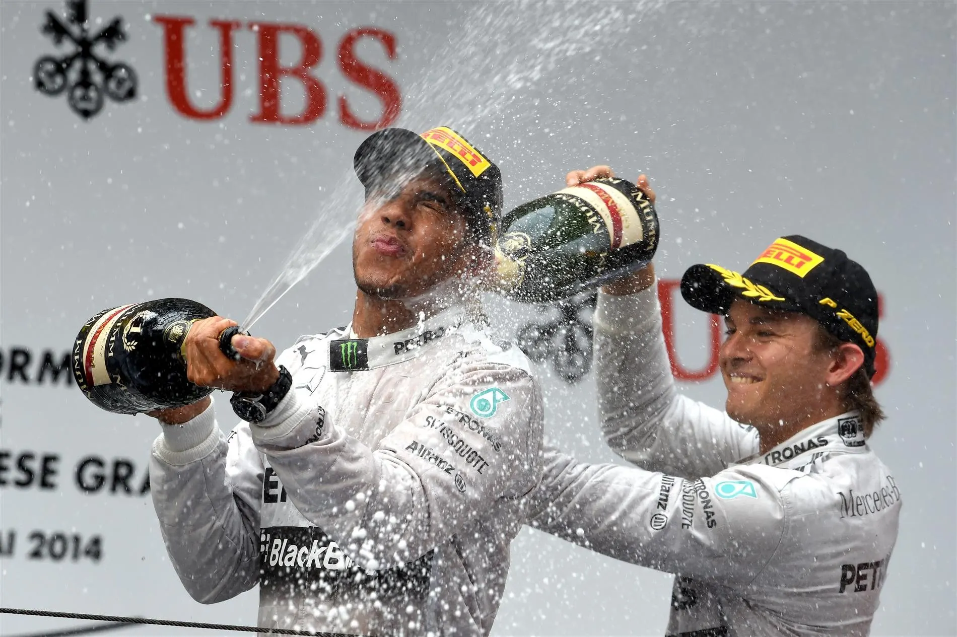 Lewis Hamilton (GBR) Mercedes AMG F1 and Nico Rosberg (GER) Mercedes AMG F1 celebrate on the podium with the champagne. Formula One World Championship, Rd4, Chinese Grand Prix, Race, Shanghai, China, Sunday, 20 April 2014