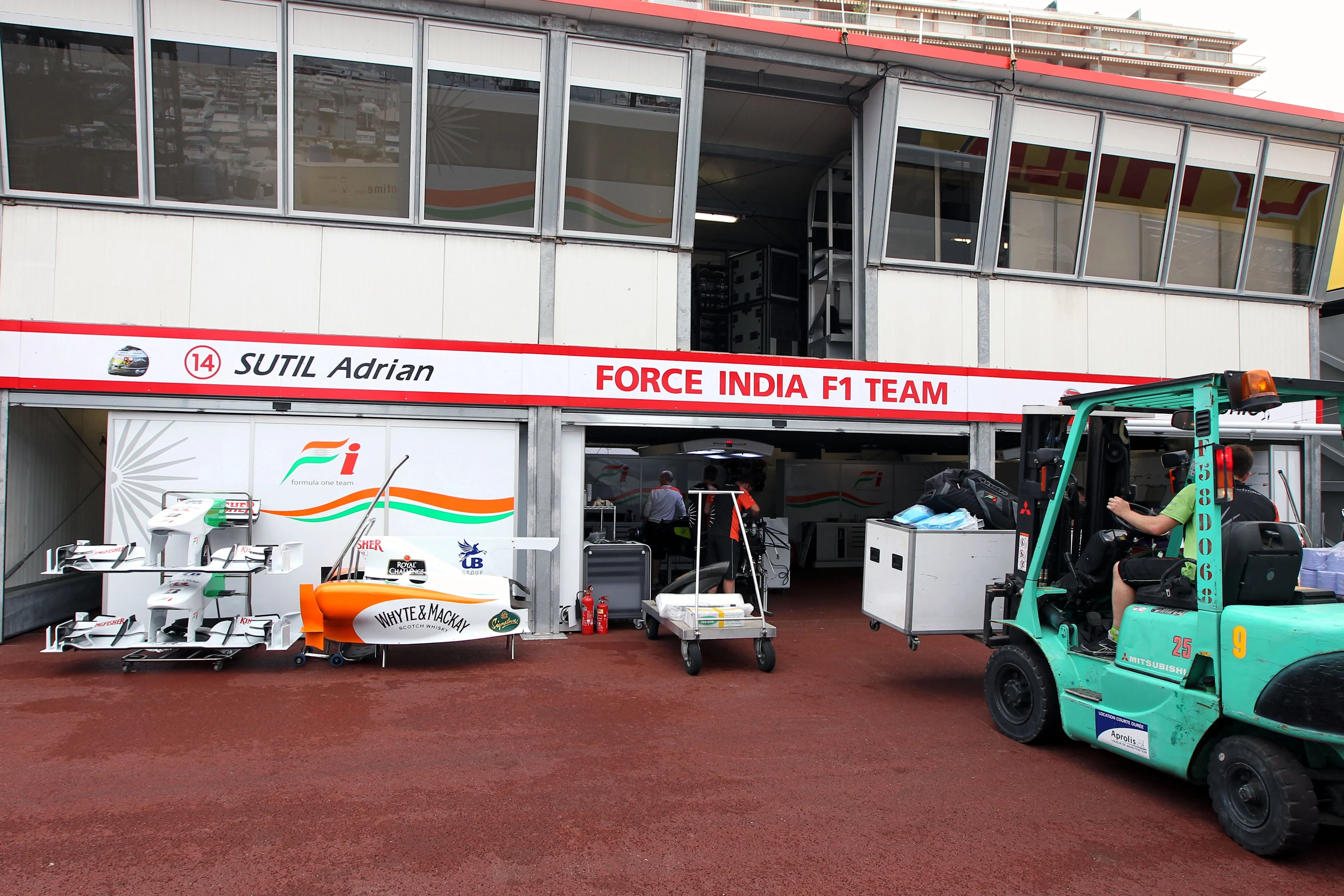 Freight is loaded into the Force India garage