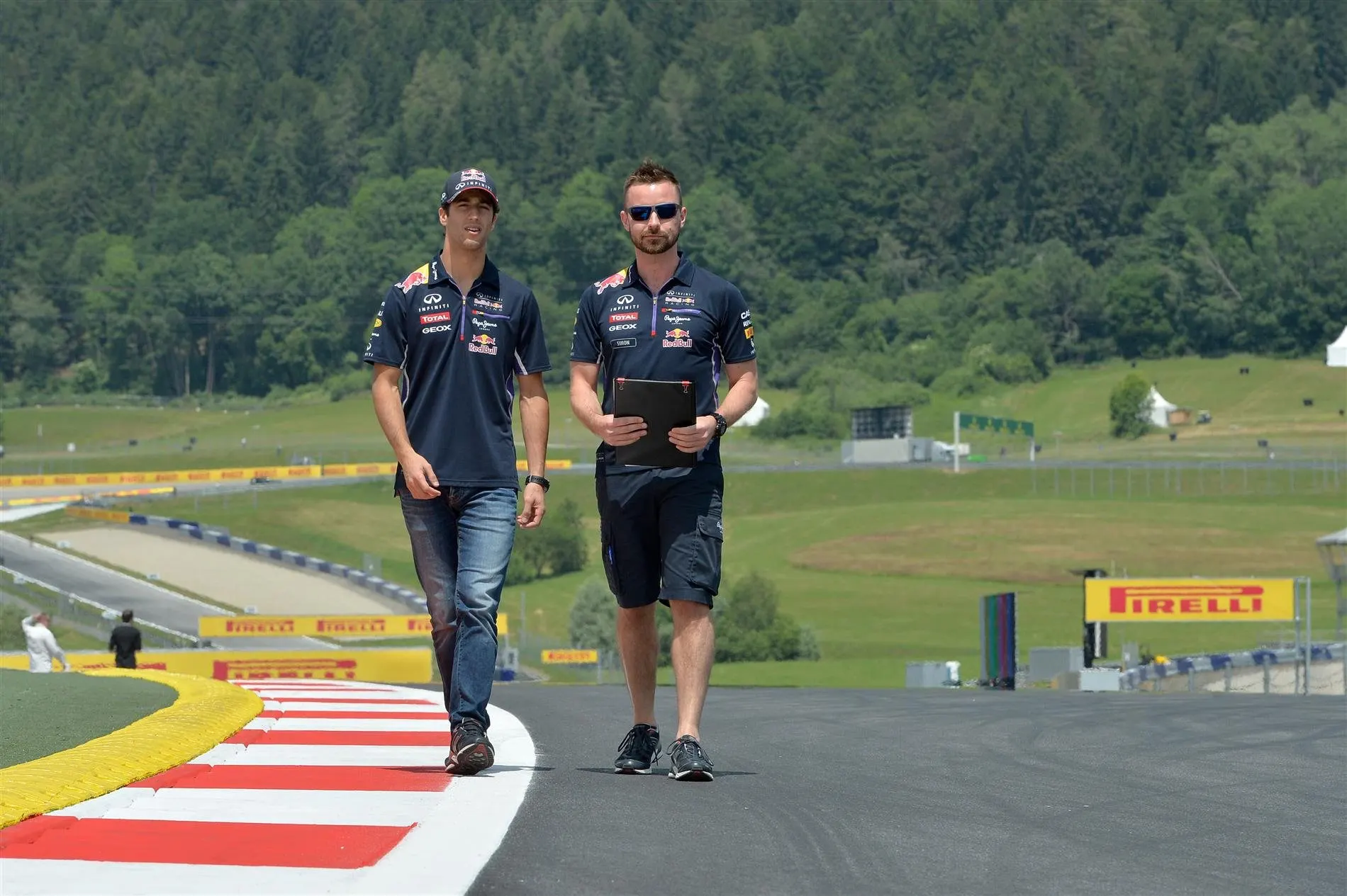 Daniel Ricciardo (AUS) Red Bull Racing walks the track with Simon Rennie (GBR) Red Bull Racing Race Engineer. Formula One World Championship, Rd8, Austrian Grand Prix, Preparations, Spielberg, Austria, Thursday, 19 June 2014