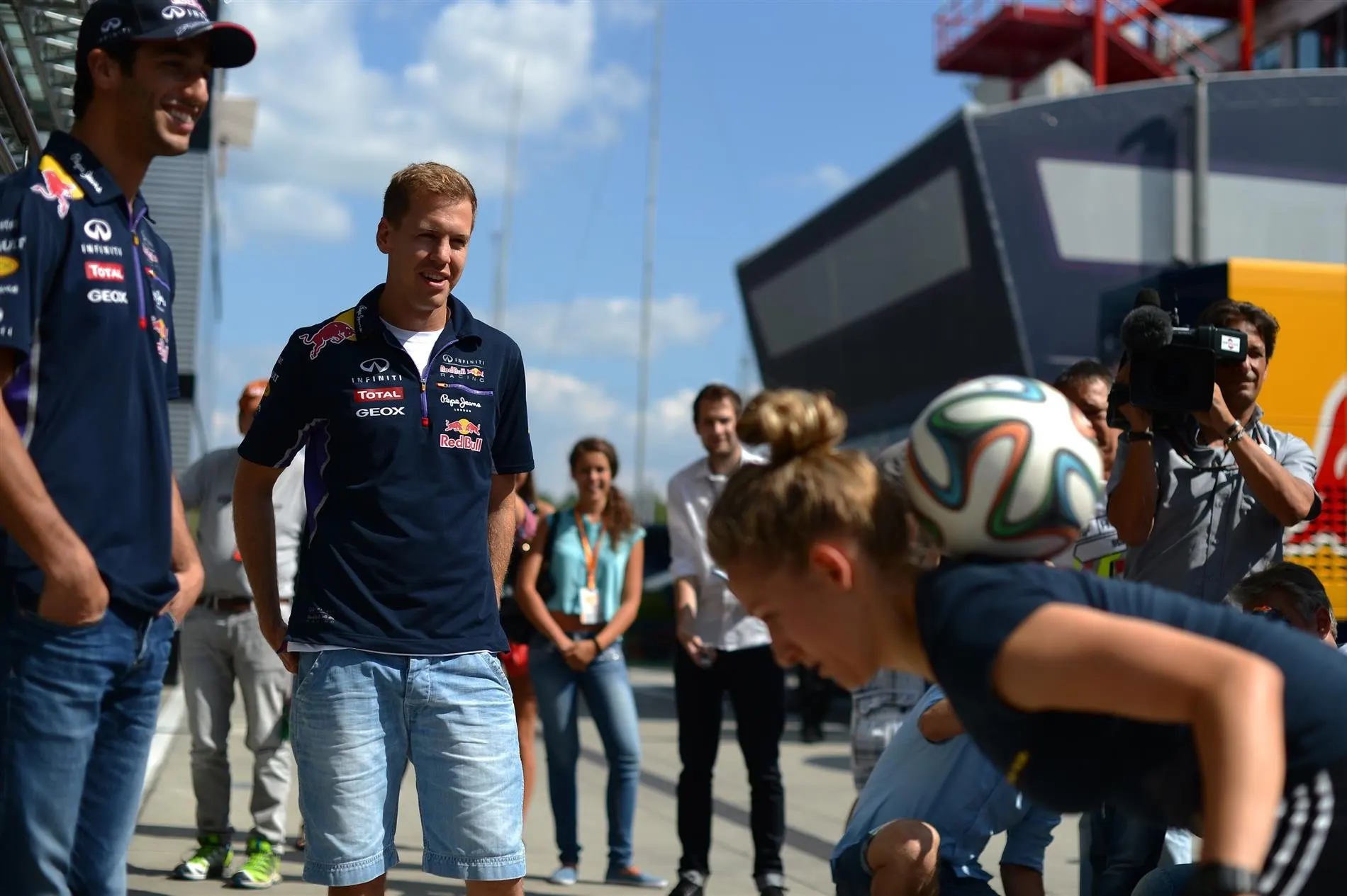 Daniel Ricciardo (AUS) Red Bull Racing and Sebastian Vettel (GER) Red Bull Racing watch soccer skills. Formula One World Championship, Rd11, Hungarian Grand Prix, Preparations, Hungaroring, Hungary. Thursday, 24 July 2014 © Sutton Images. No reproduction without permission