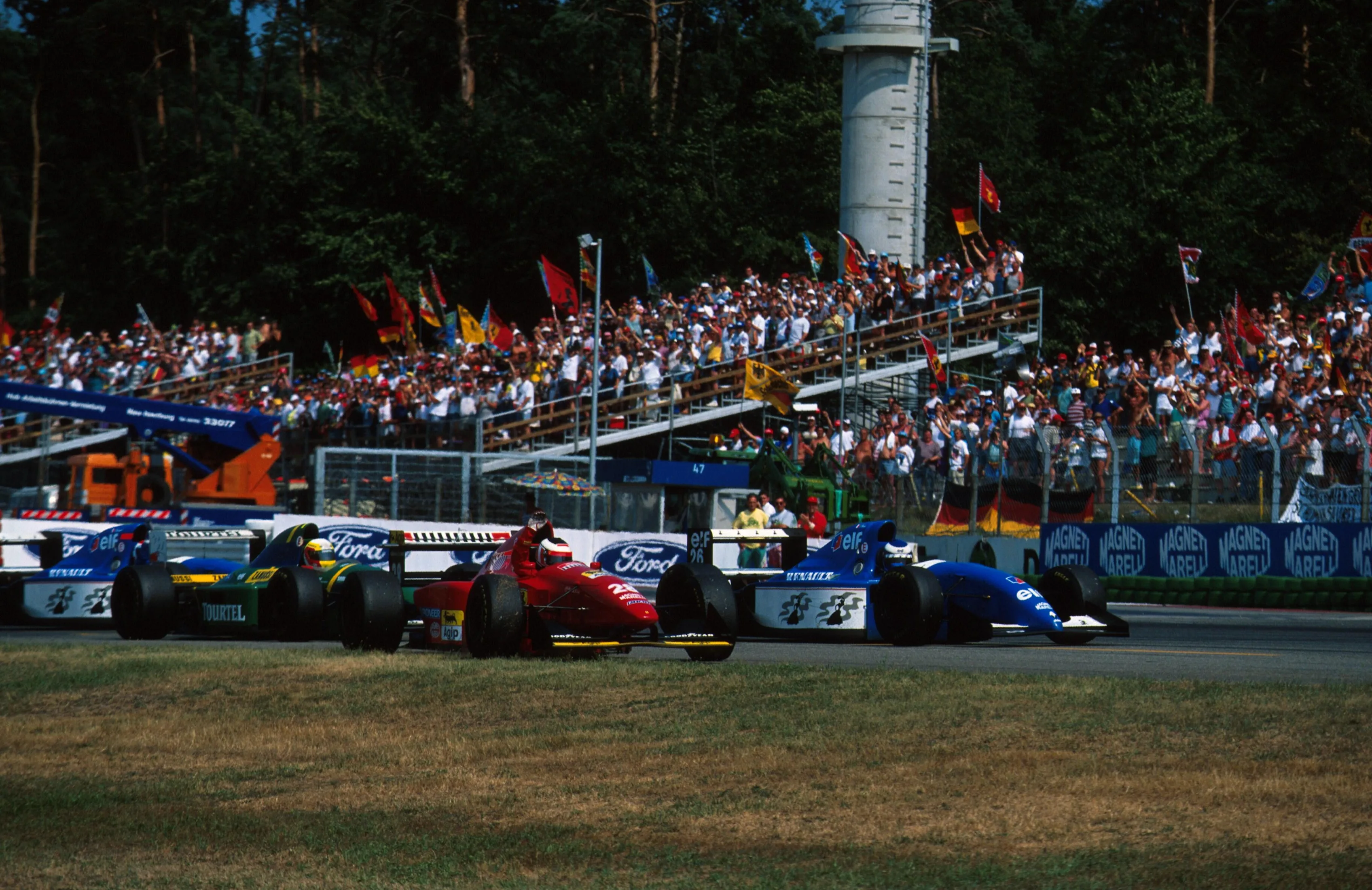 Gerhard Berger (AUT) Ferrari 412T1B celebrates his victory, closely followed by 2nd and 3rd placed drivers, Olivier Panis and Eric Bernard. German Grand Prix, Hockenheim, 31 July 1994. © Sutton Images. No reproduction without permission