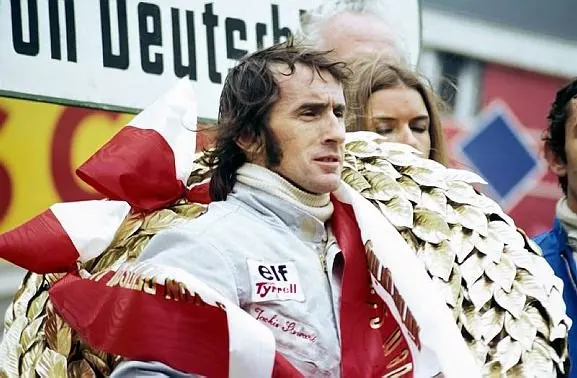 Jackie Stewart (GBR) Tyrrell celebrates his twenty-seventh and final GP victory on the podium. German Grand Prix, Nurburgring, 5 August 1973. © Sutton Images. No reproduction without permission