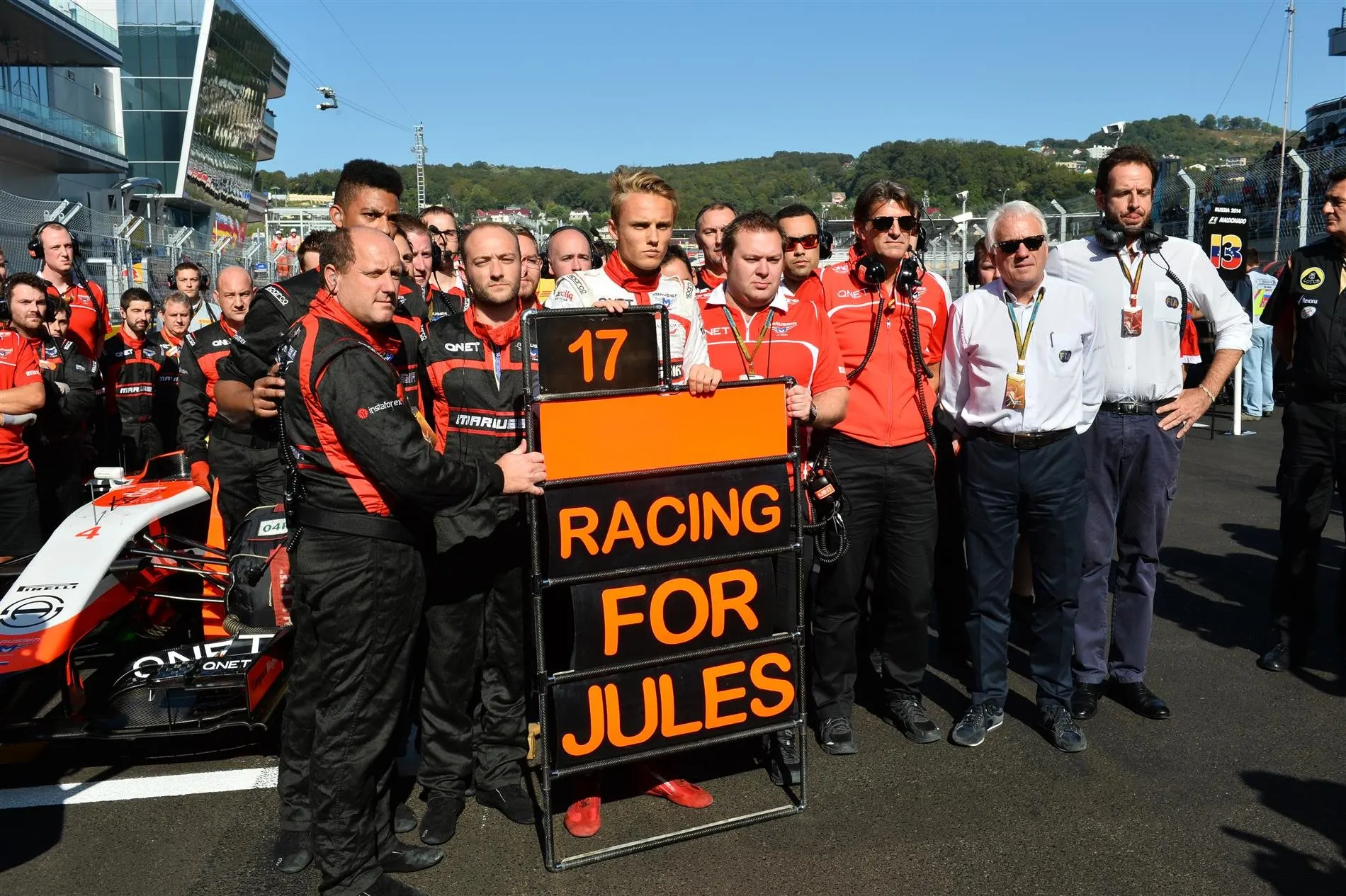 Max Chilton (GBR) Marussia F1 Team; Dave Greenwood (GBR) Marussia Chief Engineer; Graeme Lowdon (GBR) Marussia F1 President; Sporting Director and Charlie Whiting (GBR) FIA Delegate and Matteo Bonciani (ITA) FIA Media Delegate, remember the injured Jules Bianchi (FRA) Marussia F1 Team. Formula One World Championship, Rd16, Russian Grand Prix, Race, Sochi Autodrom, Sochi, Krasnodar Krai, Russia, Sunday, 12 October 2014