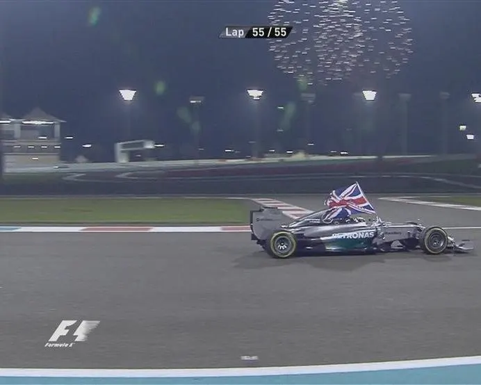 Flying the flag for Great Britain, Abu Dhabi racewinner and 2014 Formula One world champion Lewis Hamilton celebrates in the cockpit of his Mercedes © FOWC Ltd. No reproduction without permission.