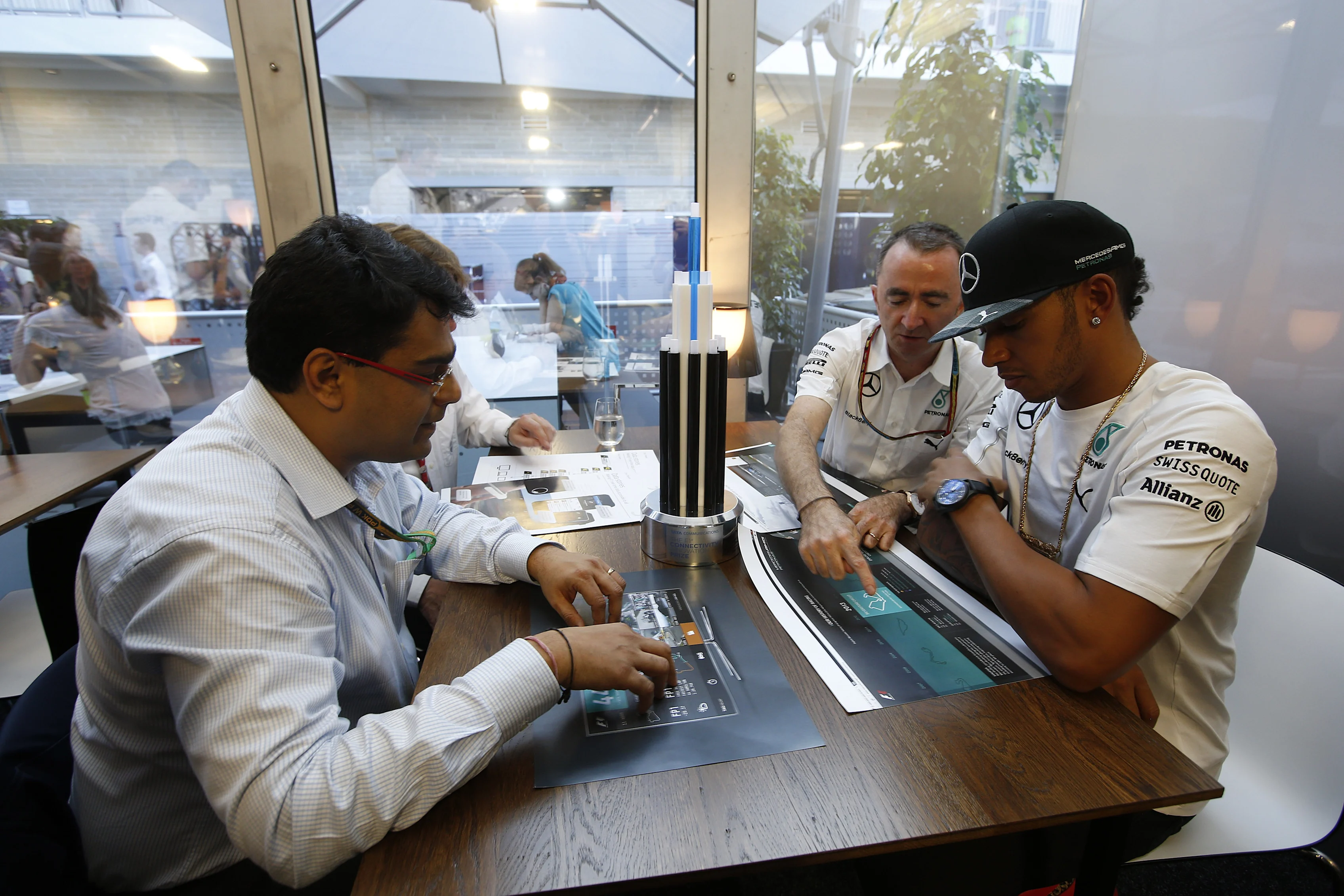 Judges discuss Tata Communications' inaugural F1 Connectivity Innovation Prize: (L to R) Mehul Kapadia, MD of the F1 Business, Tata Communications, Mercedes AMG Petronas team Executive Director (Technical), Paddy Lowe, and Mercedes driver Lewis Hamilton. © Tata Communications