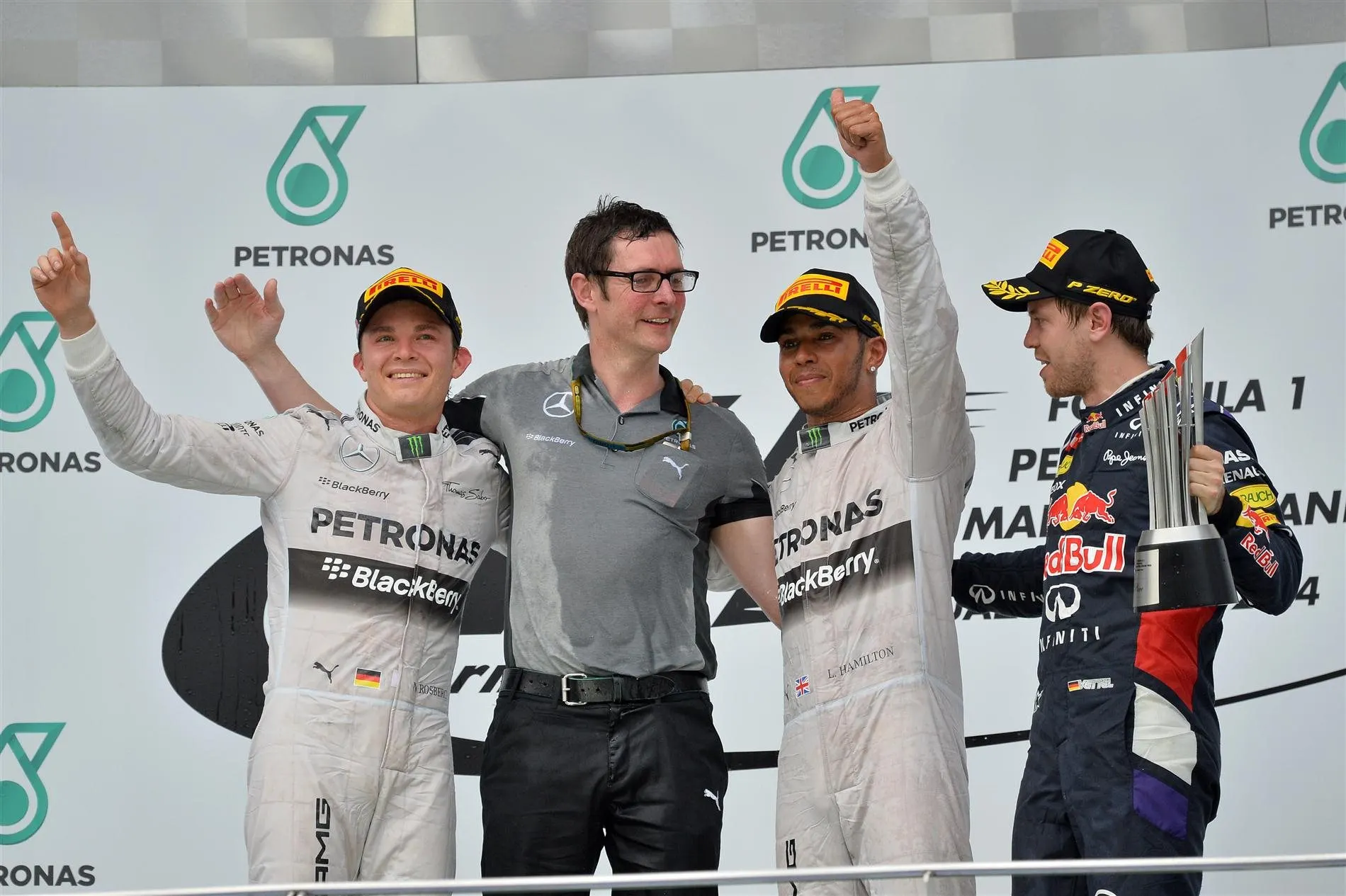 (L to R): Nico Rosberg (GER) Mercedes AMG F1, Andy Shovlin (GBR) Mercedes AMG F1 Chief Engineer, race winner Lewis Hamilton (GBR) Mercedes AMG F1 and Sebastian Vettel (GER) Red Bull Racing celebrate on the podium. Formula One World Championship, Rd2, Malaysian Grand Prix, Race, Sepang, Malaysia, Sunday, 30 March 2014. © Sutton Images