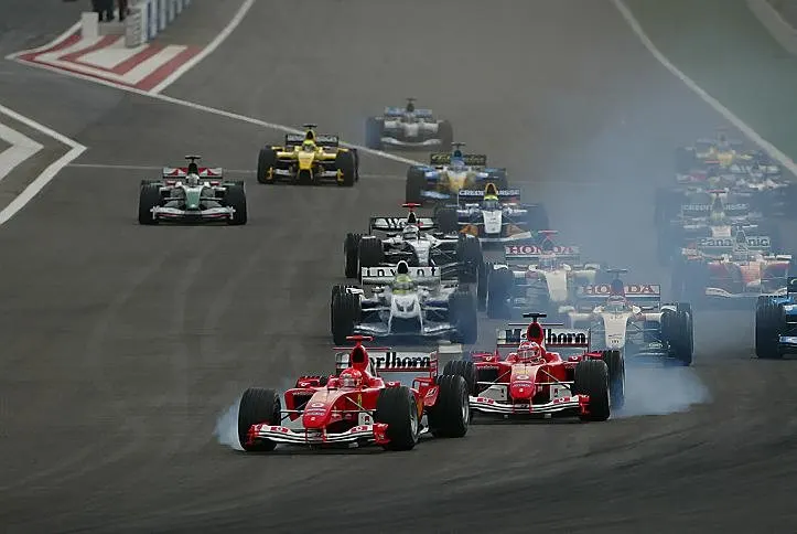 Michael Schumacher (GER) Ferrari F2004 and Rubens Barrichello (BRA) Ferrari F2004 both lock up at the start of the race. Formula One World Championship, Rd3, Bahrain Grand Prix, Race Day, Bahrain International Circuit, Bahrain, 4 April 2004 © Sutton Images. No reproduction without permission