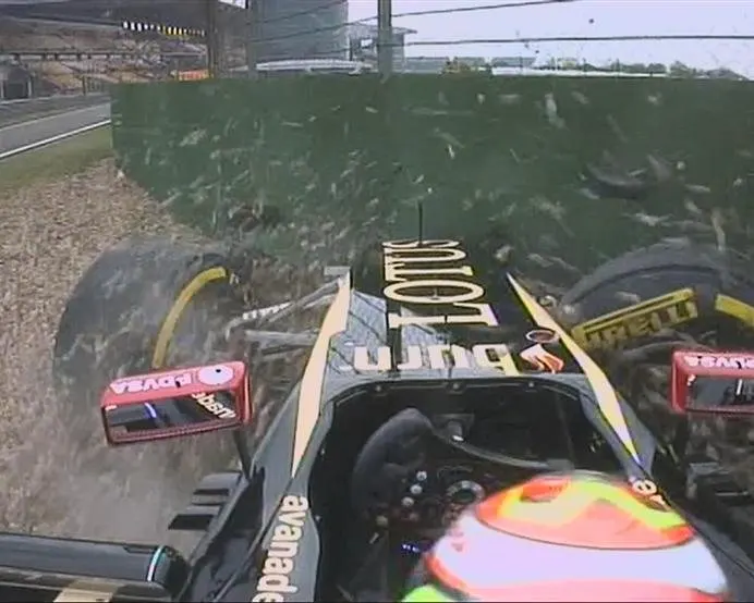 Pastor Maldonado misjudges his entry to the pit lane and crashes his Lotus into the barriers. © FOWC Ltd