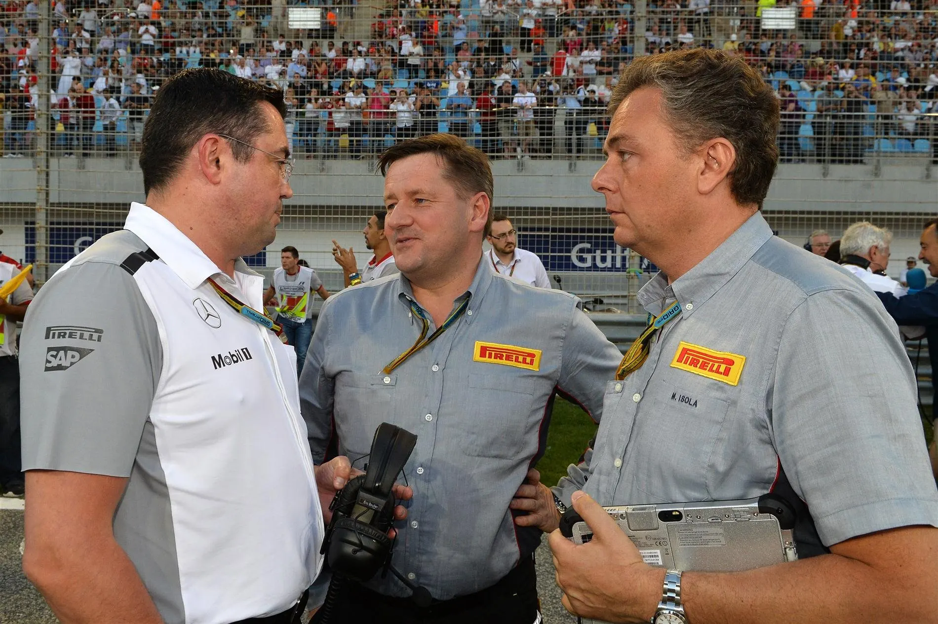 (L to R): Eric Boullier (FRA) McLaren Racing Director, Paul Hembery (GBR) Pirelli Motorsport Director and Mario Isola (ITA) Pirelli Sporting Director on the grid. Formula One World Championship, Rd3, Bahrain Grand Prix, Race, Bahrain International Circuit, Sakhir, Bahrain, Sunday, 6 April 2014. © Sutton Images