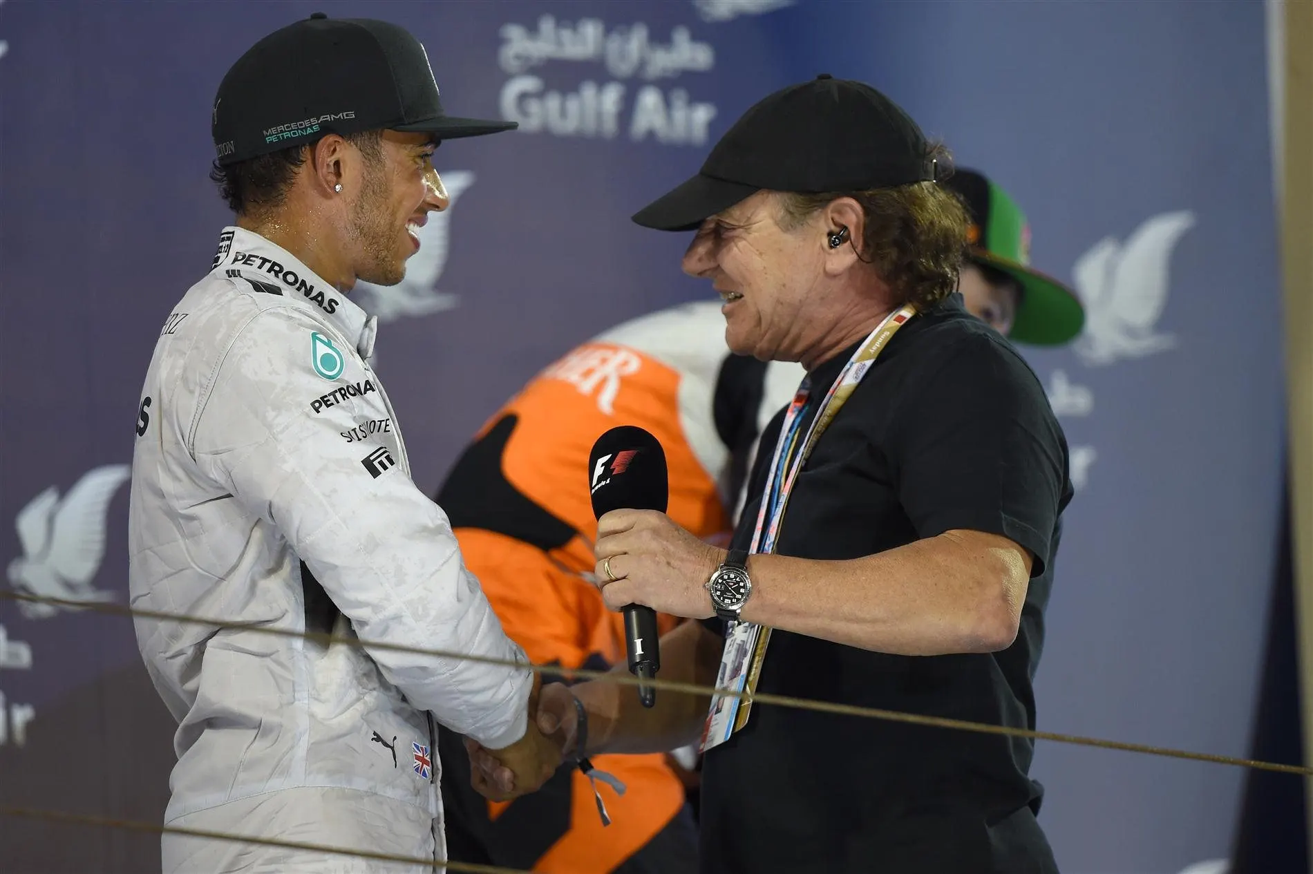 Race winner Lewis Hamilton (GBR) Mercedes AMG F1 with Brian Johnson (GBR) AC/DC lead singer on the podium. Formula One World Championship, Rd3, Bahrain Grand Prix, Race, Bahrain International Circuit, Sakhir, Bahrain, Sunday, 6 April 2014. © Sutton Images