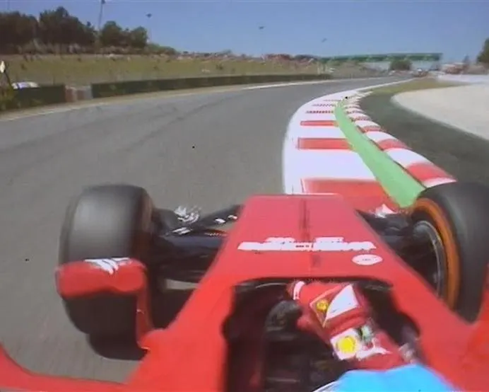 Fernando Alonso fights his Ferrari F14 T as he rumbles over the kerbs at Turn 8. © FOWC Ltd