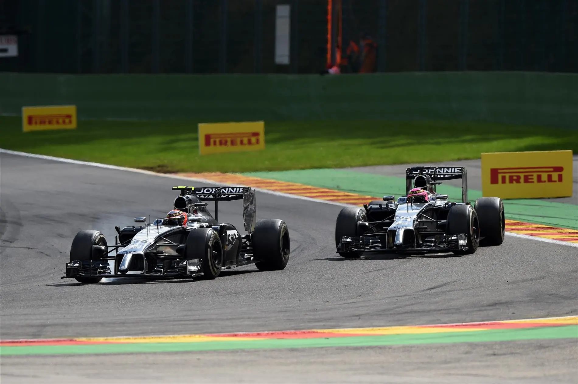 Jenson Button (GBR) McLaren MP4-29 and Kevin Magnussen (DEN) McLaren MP4-29 battle. Formula One World Championship, Rd12, Belgian Grand Prix, Race Day, Spa-Francorchamps, Belgium, Sunday, 24 August 2014. © Sutton Images