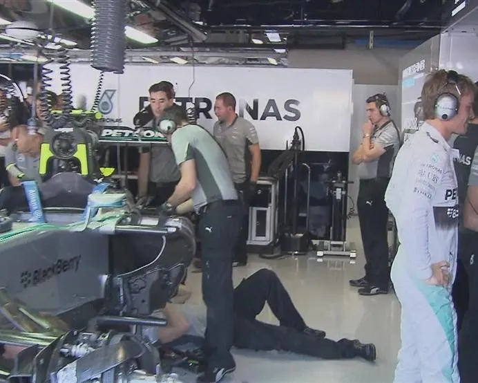 Nico Rosberg watches the action from the Mercedes garage, while his mechanics work on a gearbox issue that rules him out of FP3. © FOWC Ltd